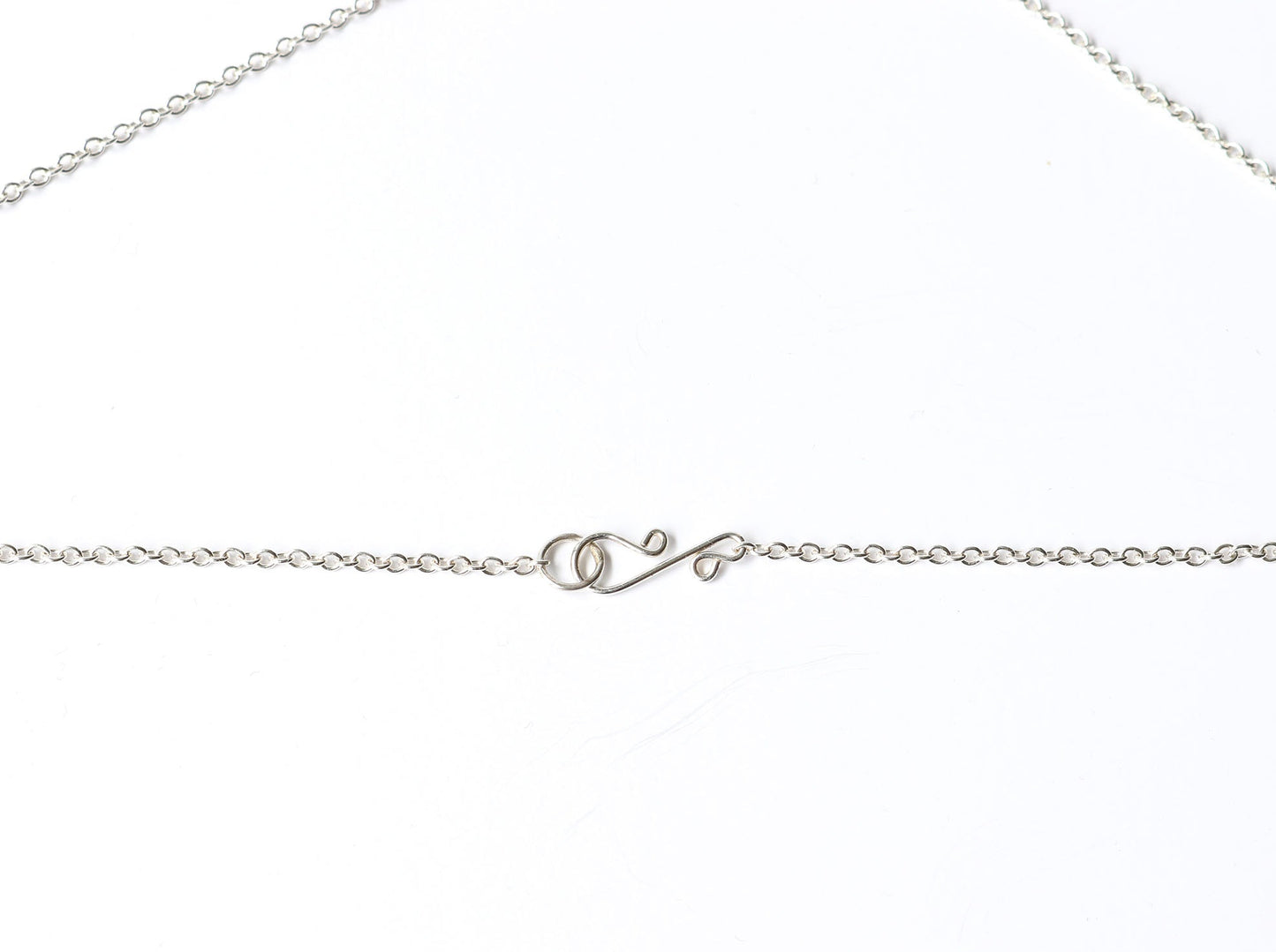 Closeup of s-hook clasp and 1.7mm necklace in Argentium Silver.