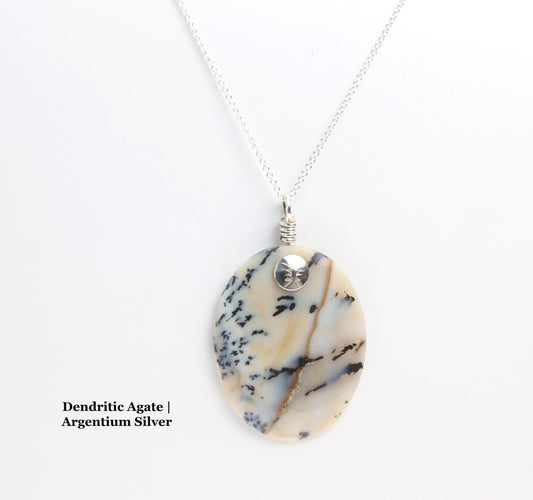 Unique Gemstone: Dendritic Agate with intricate black inclusions and translucent beauty.  Handcrafted Excellence: Polished cabochon design 
Sustainable Materials: Crafted with 100% recycled Argentium 935 Silver.