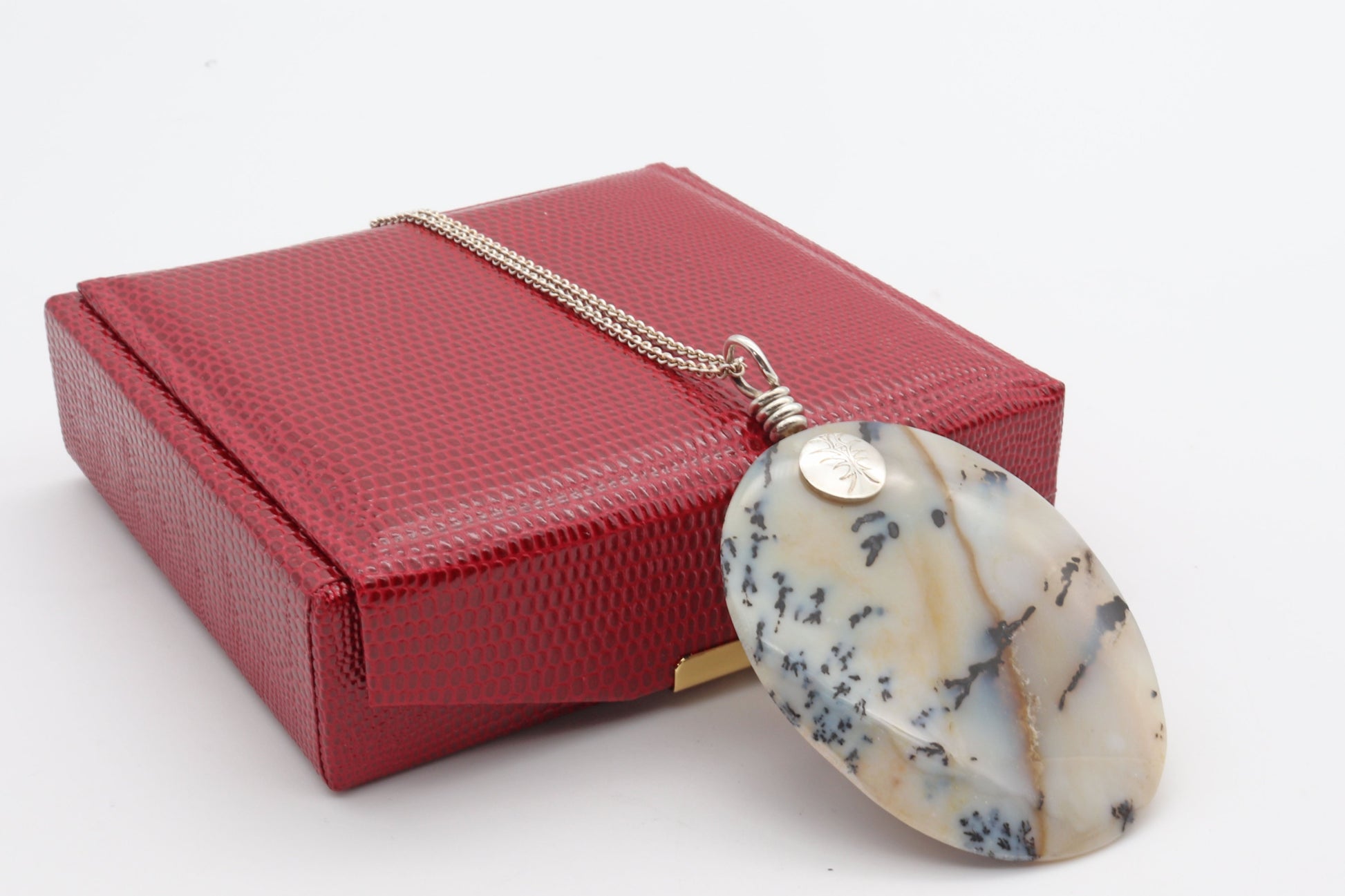 A  2.62 inch Dendritic Agate pendant, shown against a Ready to gift in a faux red leather gift box.