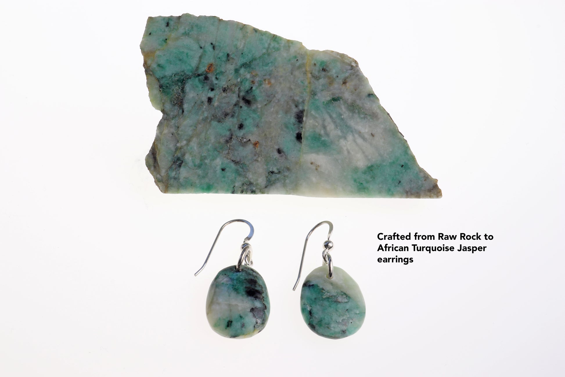 Natural African Turquoise raw rock next to tear drop earrings, to illustrate the process  of raw rock to tear drop earrings.