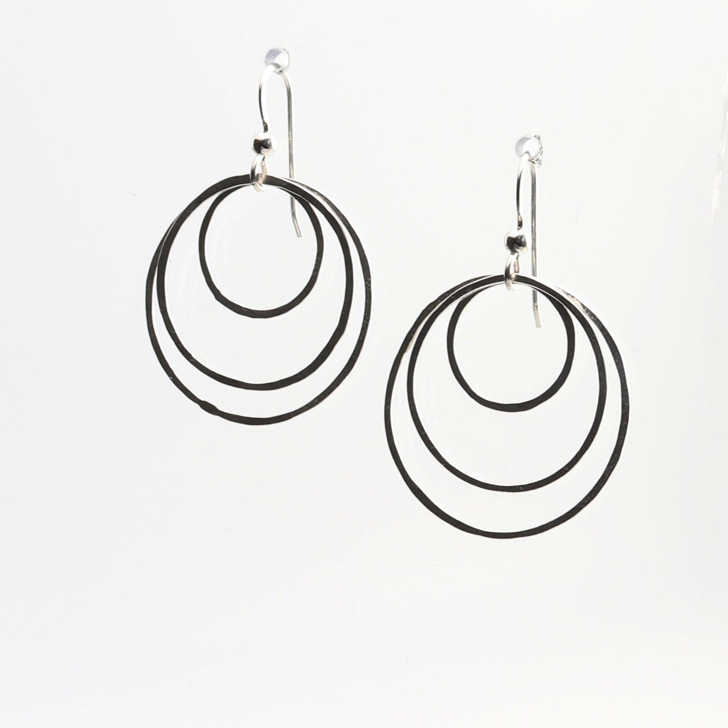 Discover the perfect blend of sustainability and style with our handcrafted hammered hoop earrings. Made from 100% recycled Argentium® 935 silver, these tarnish-resistant earrings are designed to last while maintaining their brilliant finish.