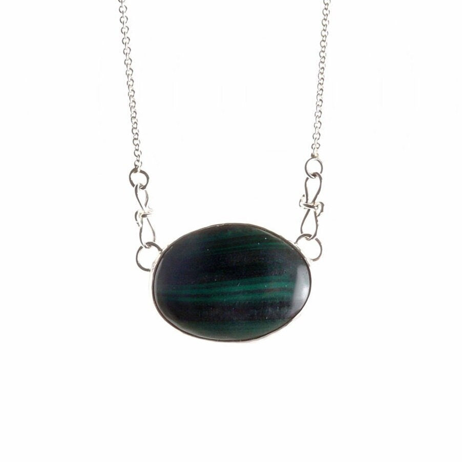 A unique Malachite gemstone pendant hand-cut and polished stone and set in solid sterling 935 Argentium® Silver. Designed with a custom chain and S hook for easy wearability.
