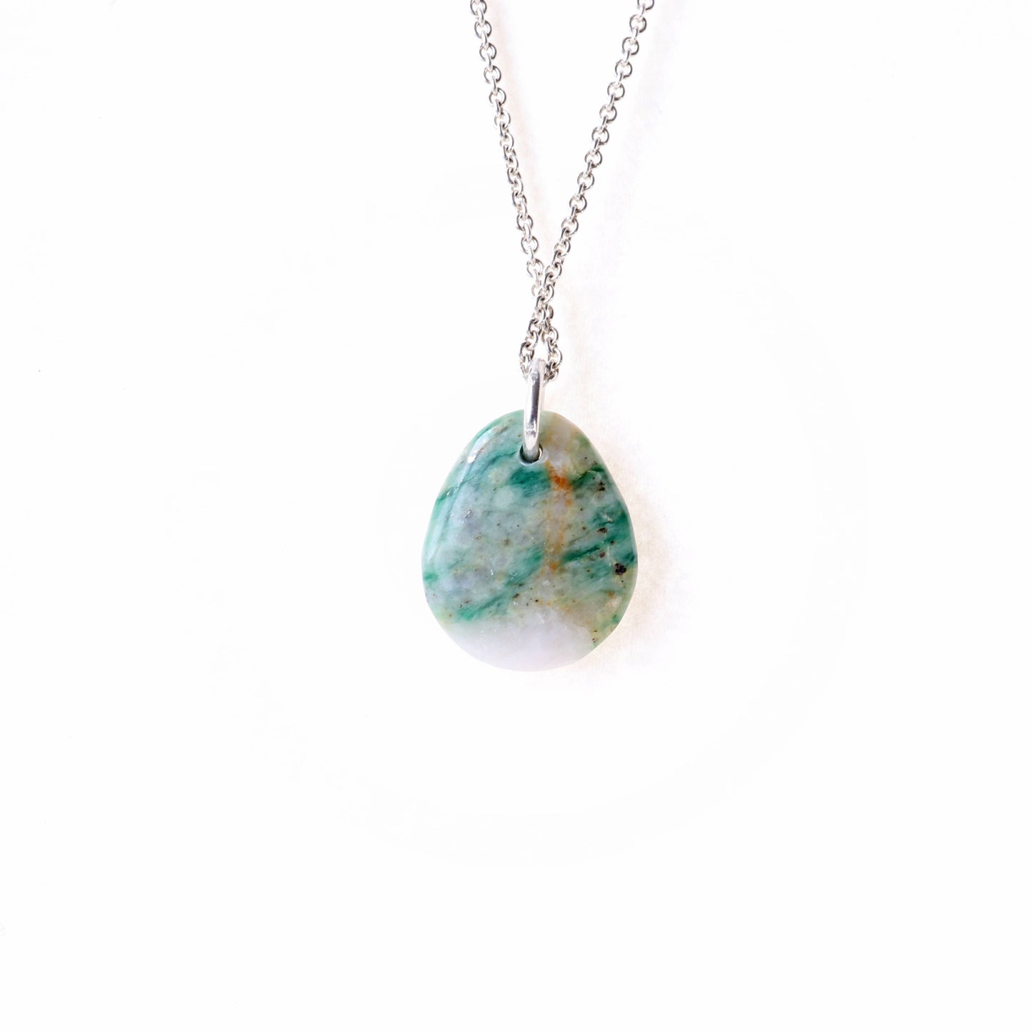 A stunning Mariposite gemstone pendant, handcrafted in Missouri, USA. This unique piece features a teardrop shape, handcut and polished on both sides to showcase the natural green and white hues of the Mariposite stone.