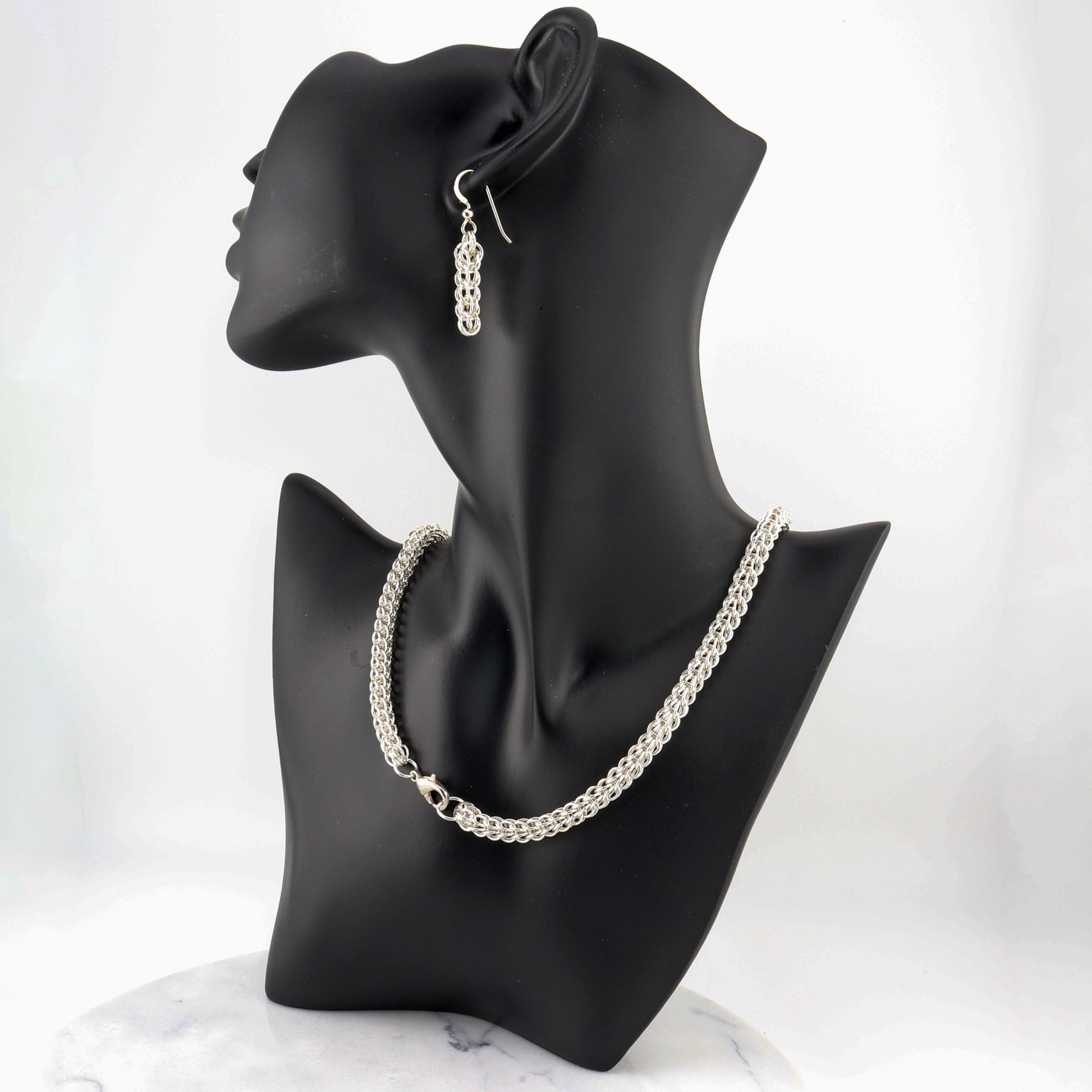 Elevate your jewelry collection with this stunning Full Persian Weave necklace, a masterpiece of timeless craftsmanship. Handcrafted from over 400 precision-cut rings of premium 935 Argentium® Silver, this necklace offers exceptional tarnish resistance and hypoallergenic properties, making it a superior choice for both durability and everyday elegance.  Pair this timeless necklace with the matching earrings for a coordinated look or let it shine on its own.