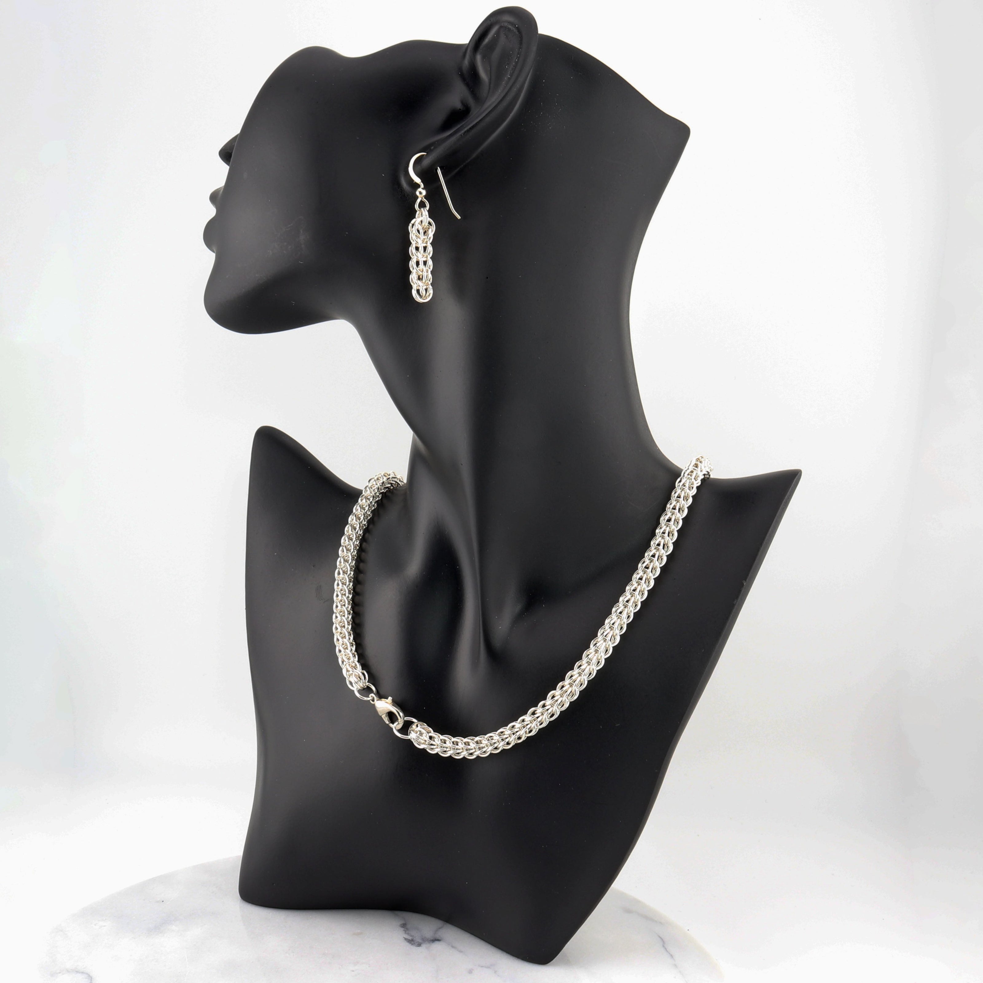 Elevate your jewelry collection with this stunning Full Persian Weave necklace, a masterpiece of timeless craftsmanship. Handcrafted from over 400 precision-cut rings of premium 935 Argentium® Silver, this necklace offers exceptional tarnish resistance and hypoallergenic properties, making it a superior choice for both durability and everyday elegance.  Pair this timeless necklace with the matching earrings for a coordinated look or let it shine on its own.