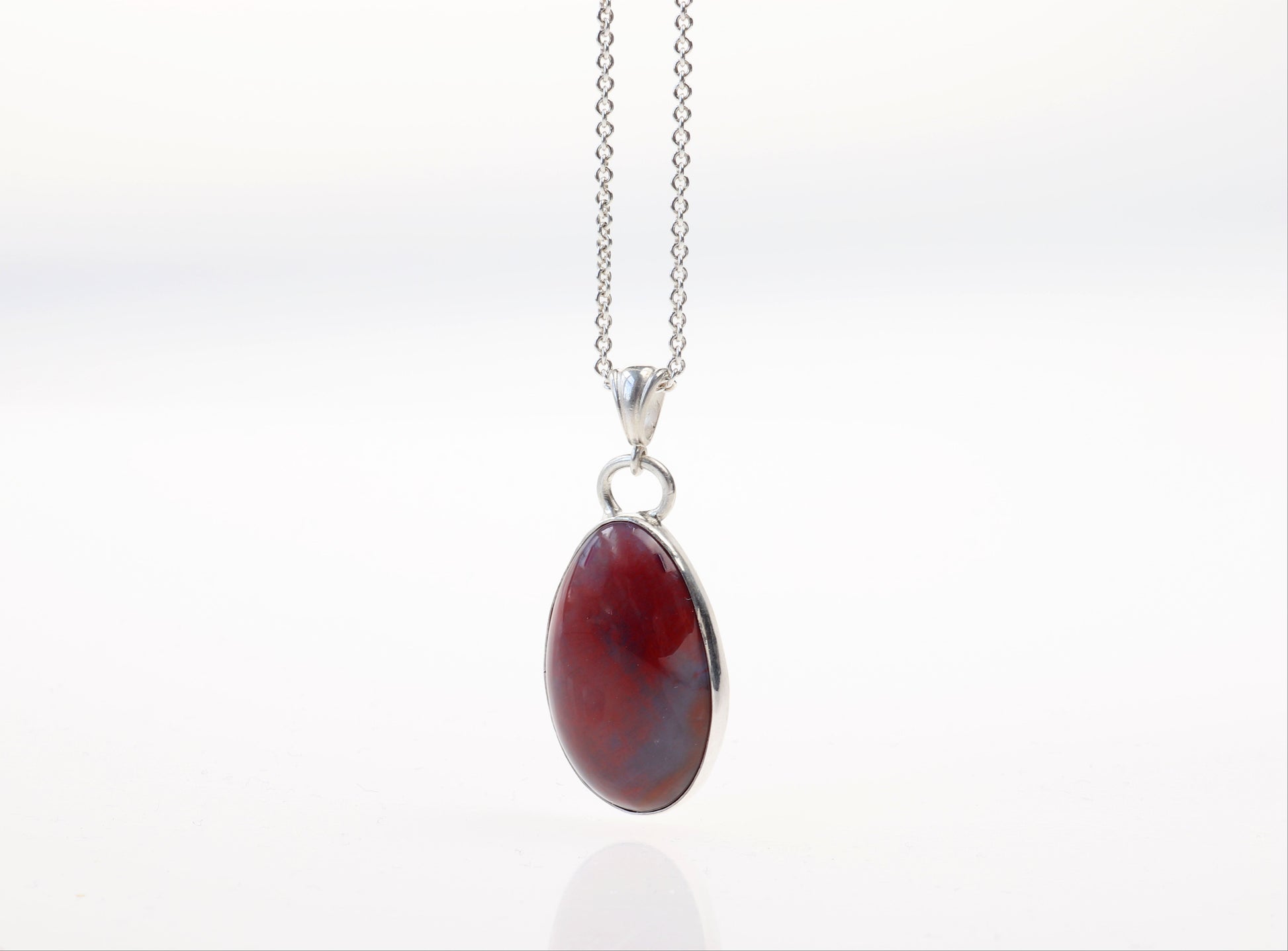 A natural Arizona Petrified Rainbow Wood, handcut and polished on both sides to showcase the translucent hues of reds and blue along with nature's intricate patterns.