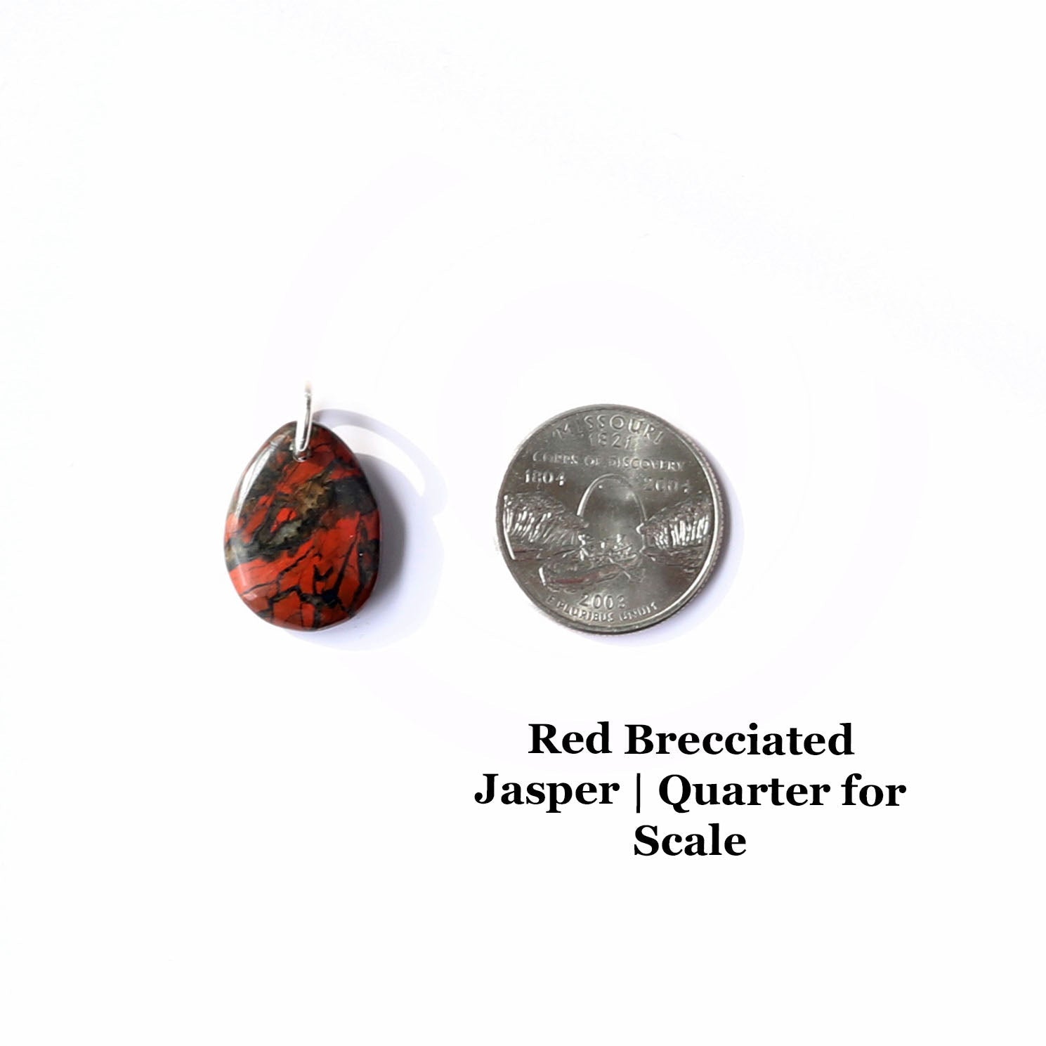 A red brecciated jasper gemstone pendant with a silver bail. The pendant is next to a US quarter for scale. Text overlay reads Red Brecciated Jasper | Quarter for Scale