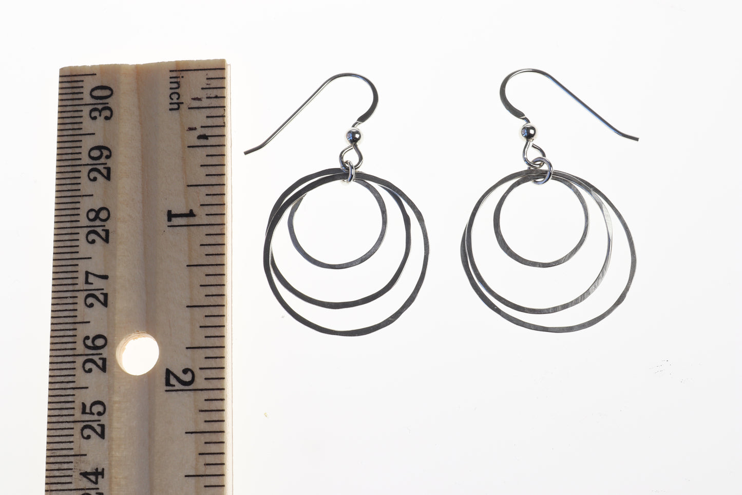 Crafted with hypoallergenic .032" Argentium ear wires, they offer lightweight comfort and a secure fit for all-day wear. Measuring 1.69" (42.9 mm) in length with a 1" (25.4 mm) diameter, these hoops are versatile enough to complement any outfit, from casual to formal.