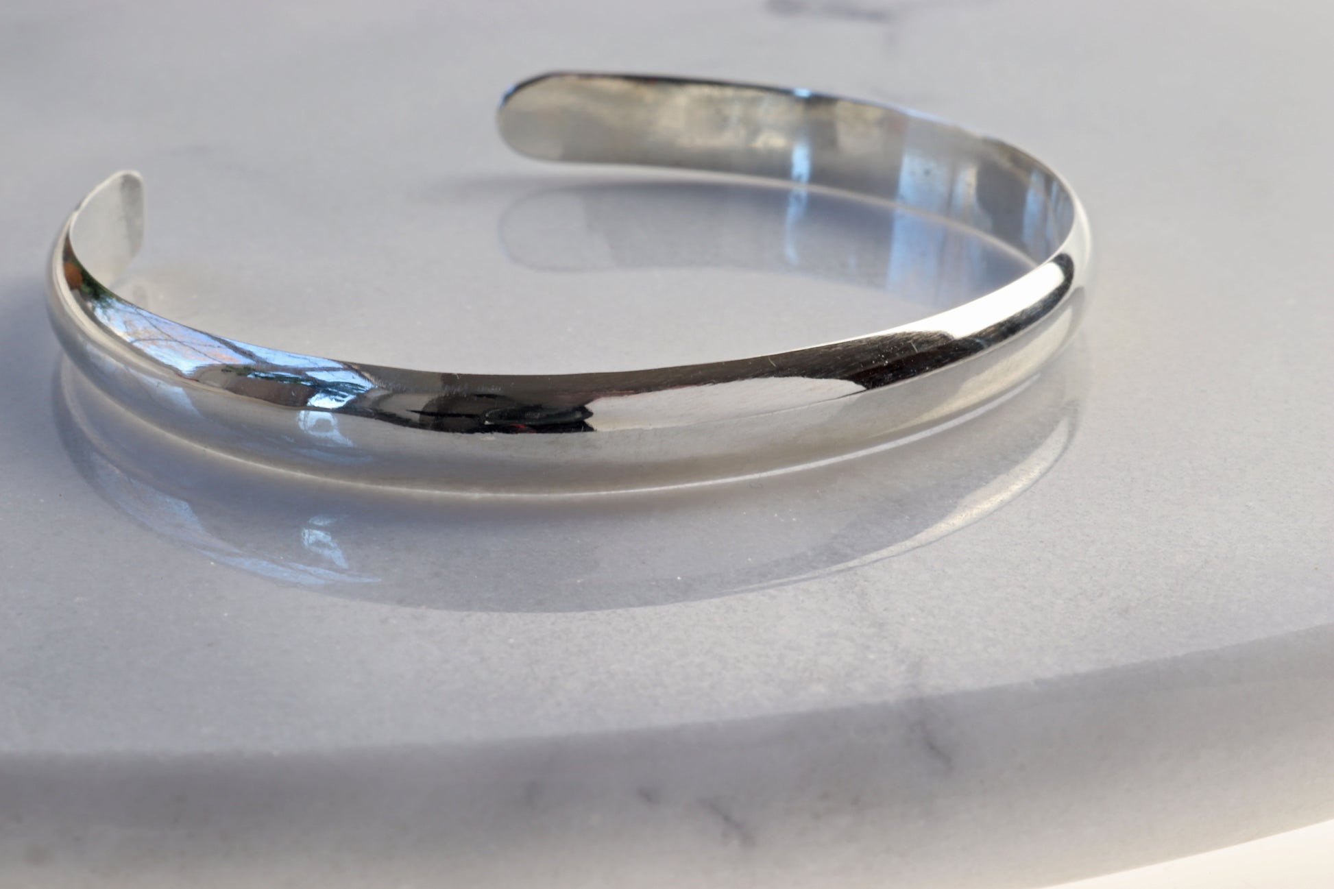 A handcrafted 6mm cuff bracelet made from solid Argentium® 935—a premium silver alloy known for its luminous shine, tarnish resistance, and hypoallergenic properties