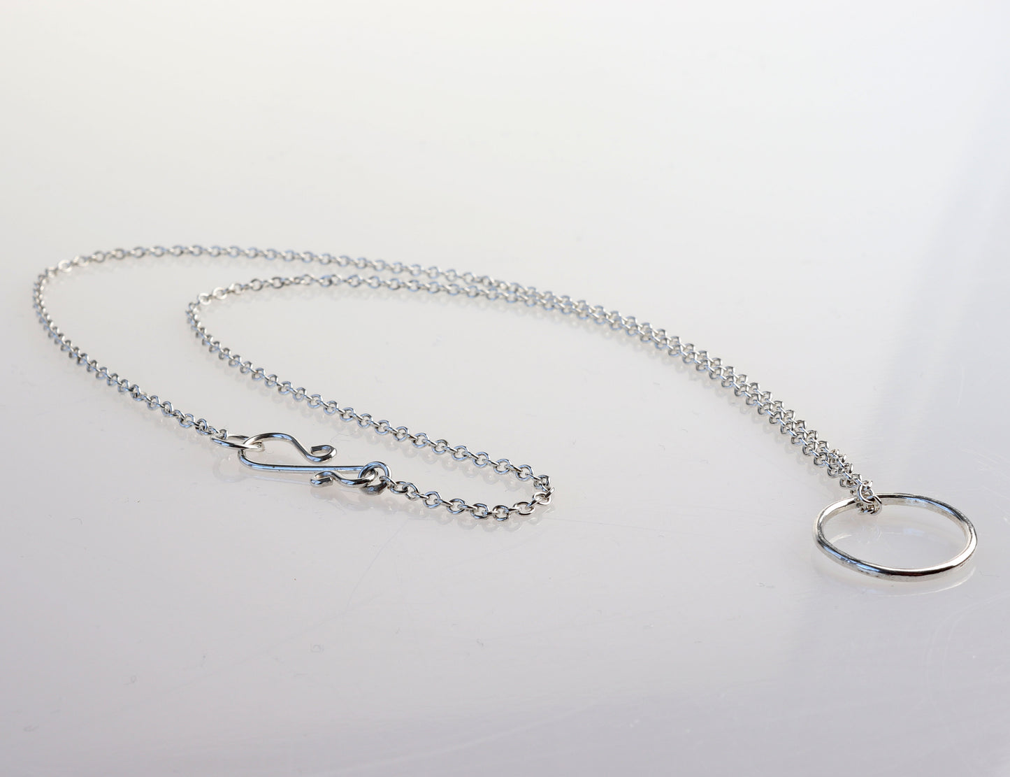Elevate your jewelry collection with this handcrafted Open Circle Pendant Necklace, made from premium 935 Argentium® sterling silver. This versatile necklace is designed to be worn with or without the pendant and can be personalized with your favorite charms. Known for its hypoallergenic properties, tarnish resistance, and sustainability, 935 Argentium® silver is crafted from 100% recycled materials and has a higher silver content than traditional 925 sterling silver.