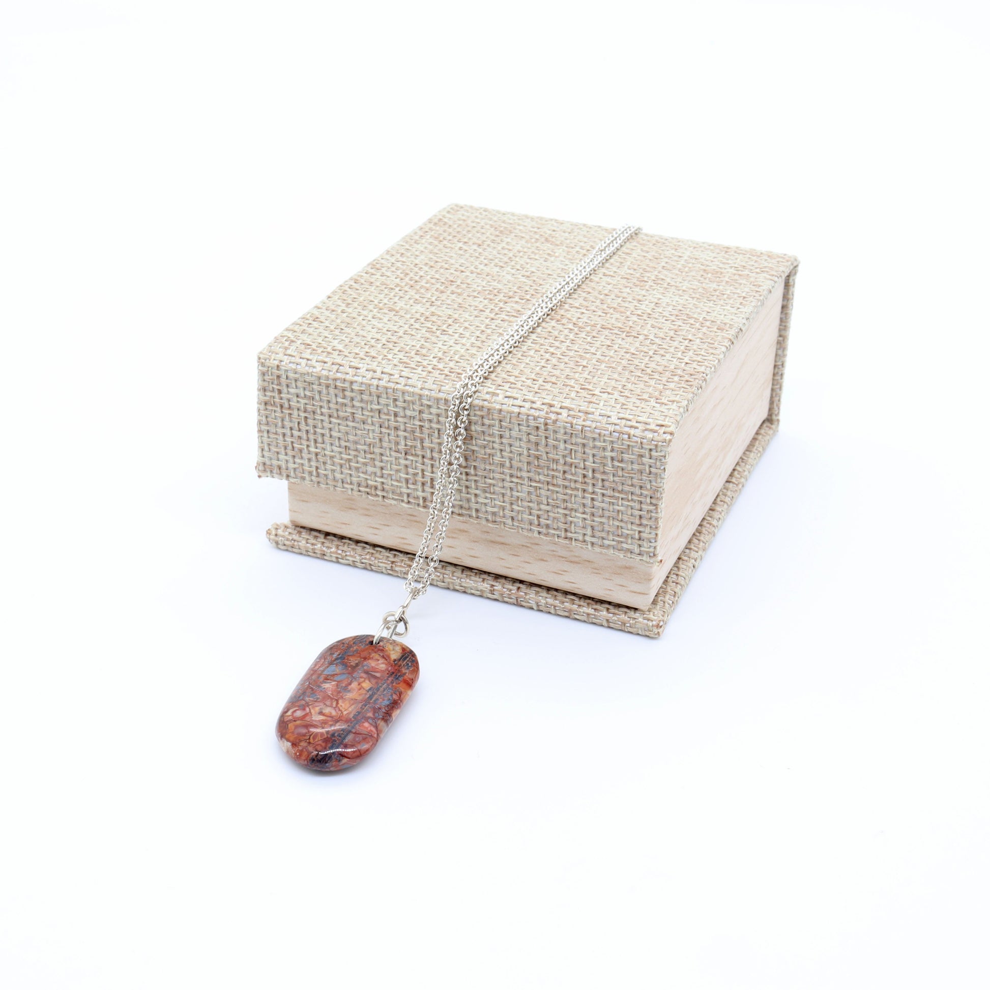 A Stony Creek Jasper gemstone pendant. Shown on white background with a Cabana Burlap and Wood-Patterned Pendant gift box ready to gift.