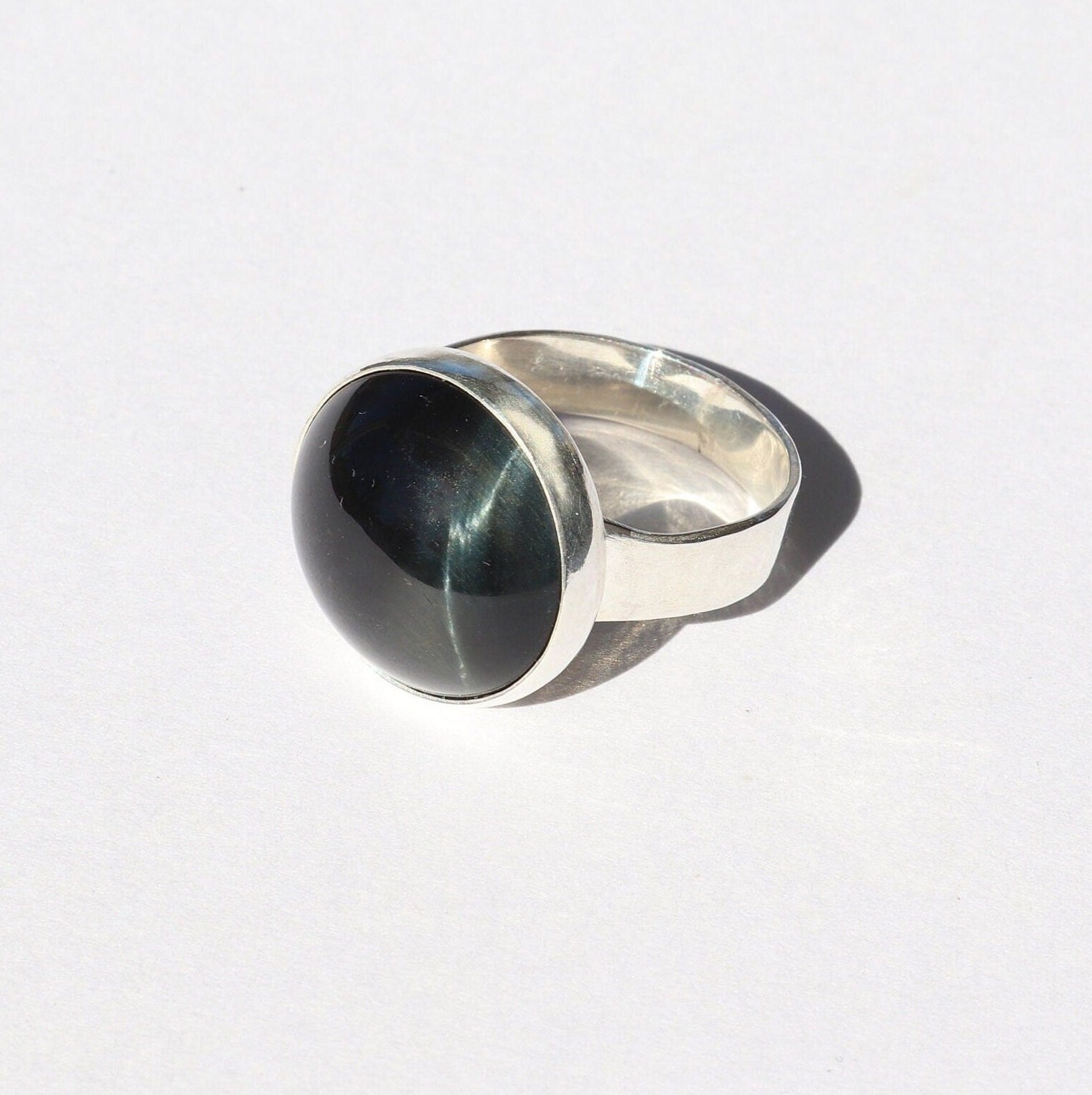 African Blue Tiger’s Eye ring in Argentium® 935 Silver, size 7.5, featuring a deep blue handcut cabochon with chatoyancy.