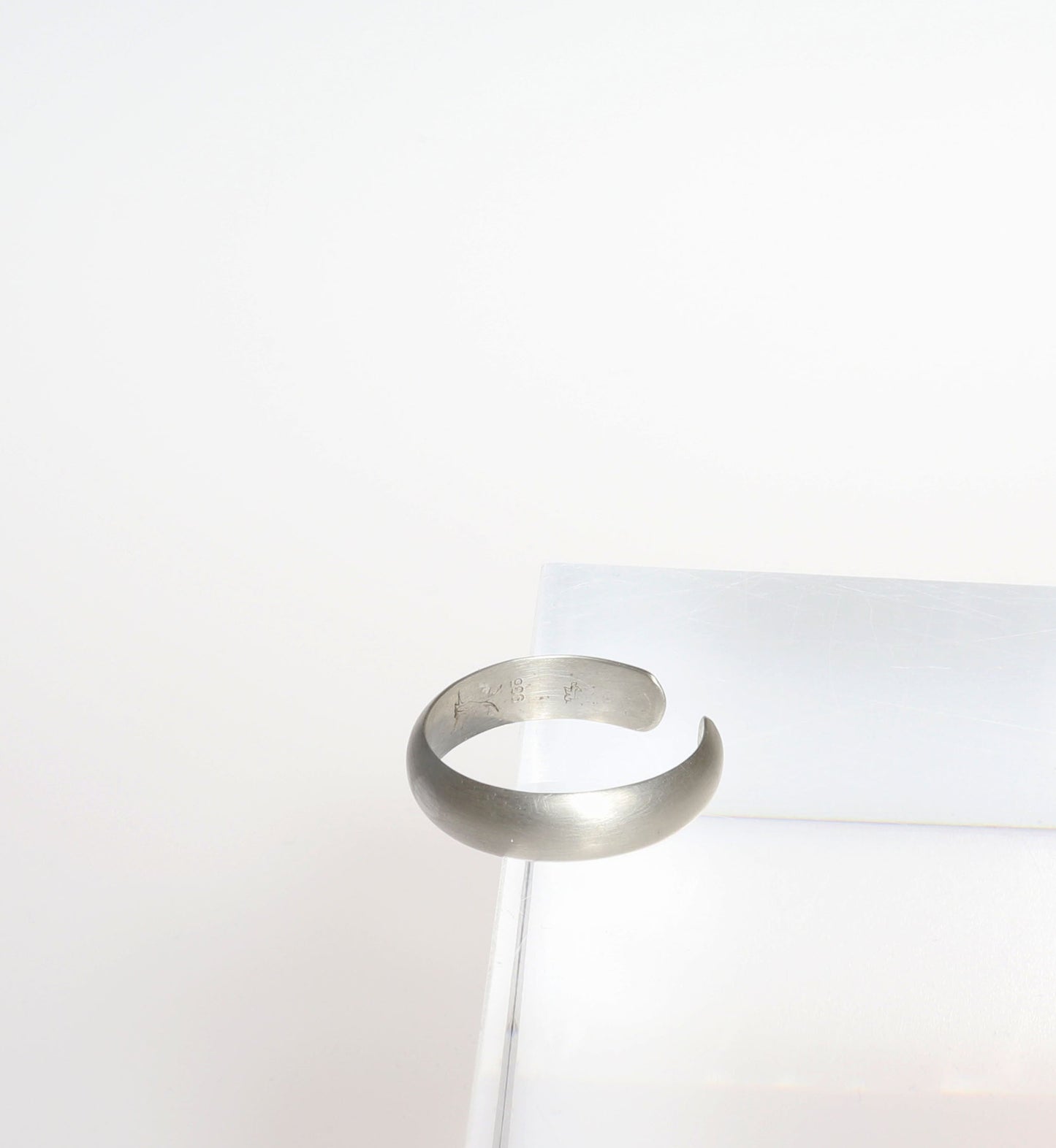 Side view of a Argentium Silver half dome ring on a white background