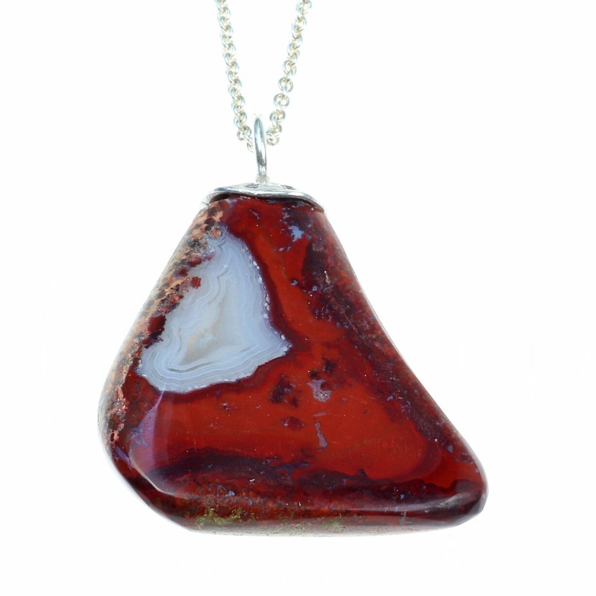 Reverse side of this 1.81 inch Red Jasper Agate Pendant, handcrafted in our small town Missouri studio. Handcut and freeform polished on both sides, showcasing the captivating patterns and rich red hues of this reversible piece. The custom crafted bail in sterling 935 Argentium Silver adds a touch of elegance.