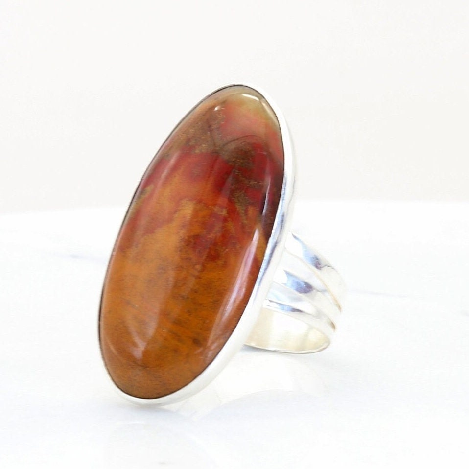 Closeup of a vivid red orange and brown Sonoran Sunrise gemstone ring  set in a handcrafted band of Argentium® 935 Silver.