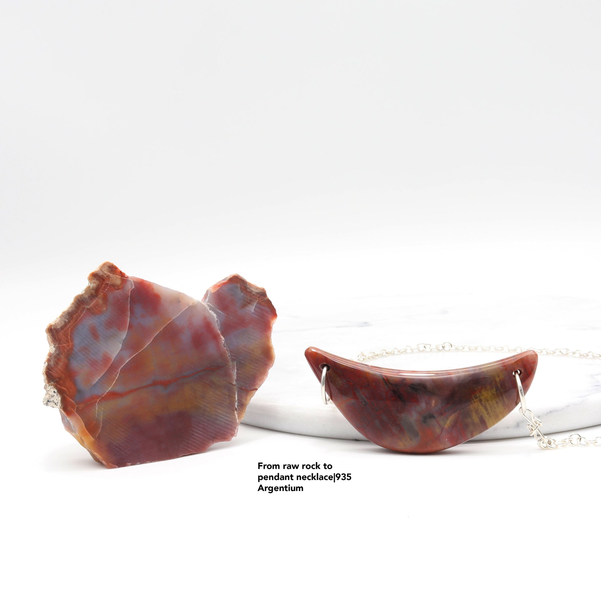 The rock used to craft this pendant next to the pendant.  Text Overlay from raw rock to pendant necklace 935 Argentium.