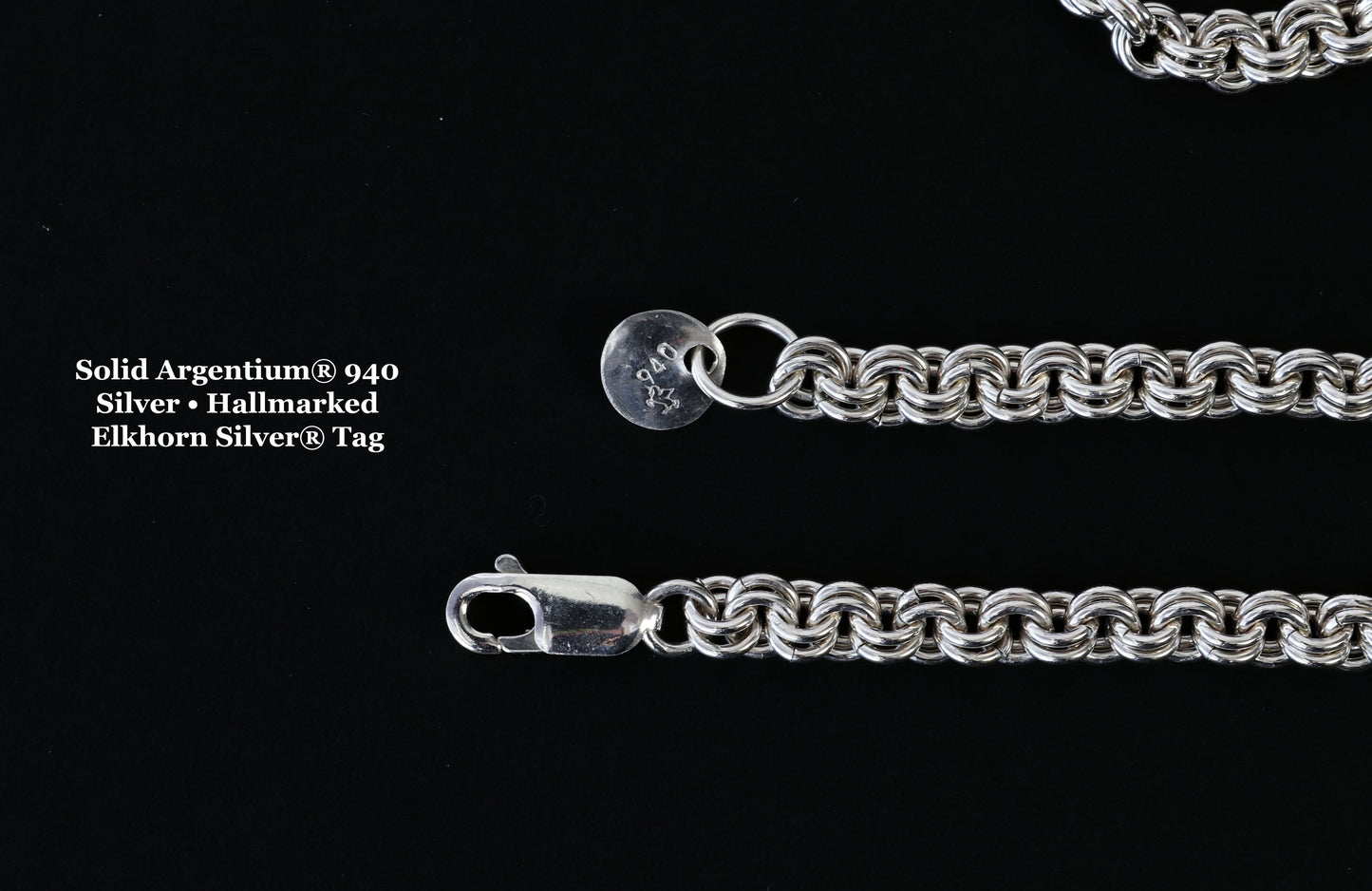 Close-up of Argentium® 940 silver jewelry tag showing the official unicorn hallmark on one side and Elkhorn Silver® maker’s mark on the other.