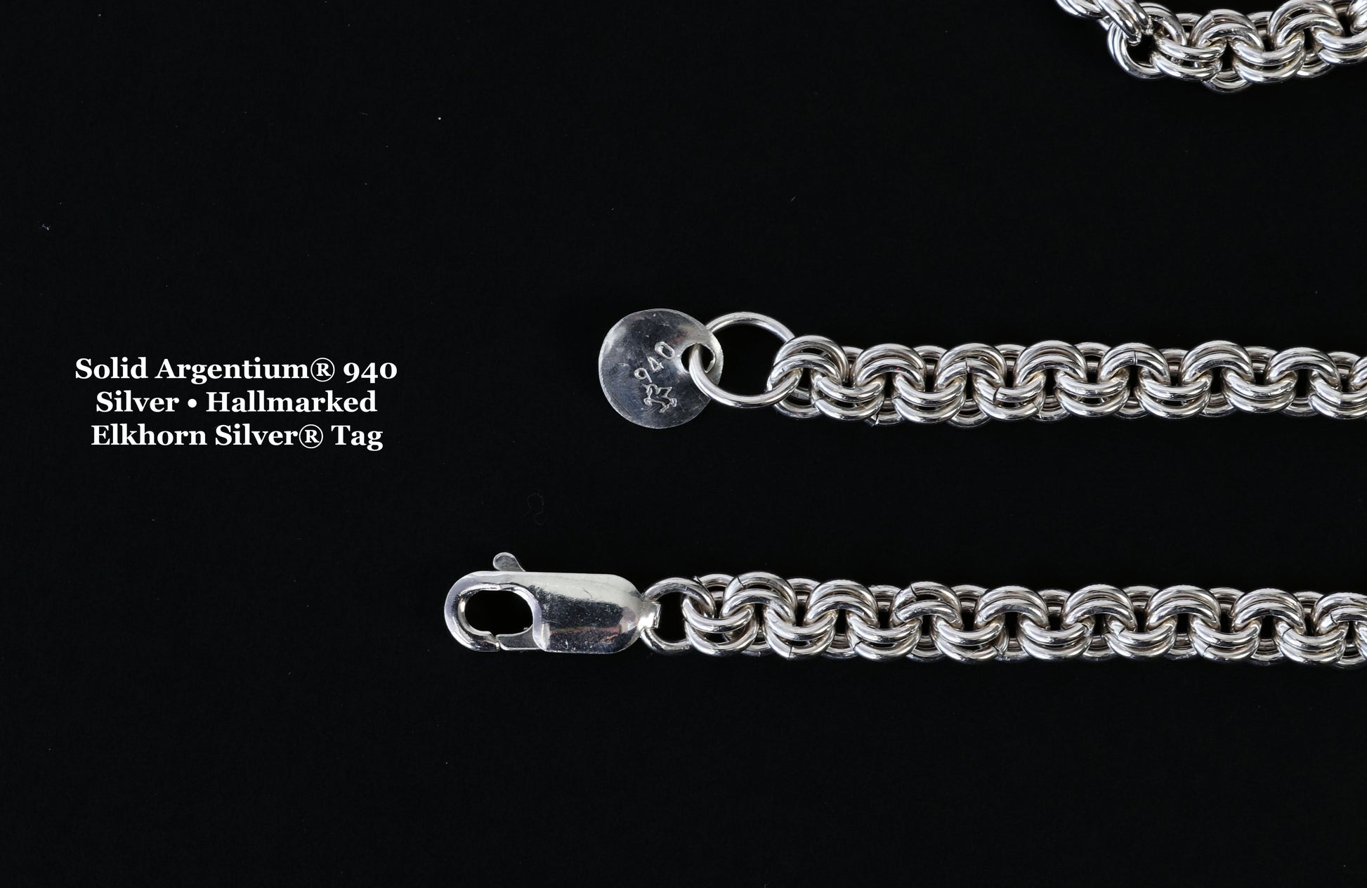Close-up of Argentium® 940 silver jewelry tag showing the official unicorn hallmark on one side and Elkhorn Silver® maker’s mark on the other.
