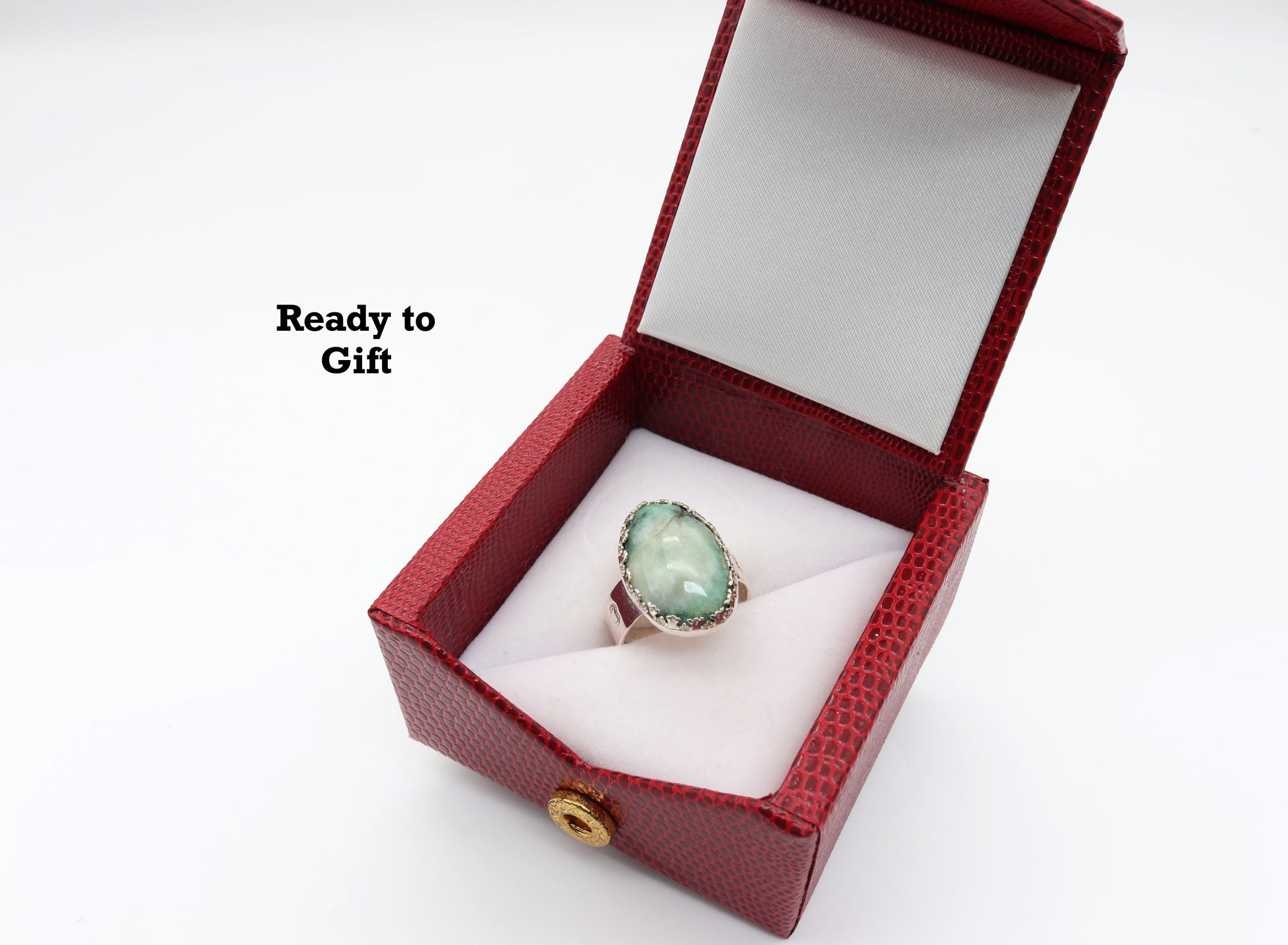 Oval turquoise ring set in Argentium silver featuring black matrix patterns within a turquoise blue green natural stone.  Shown in red faux leather gift box included in purchase.