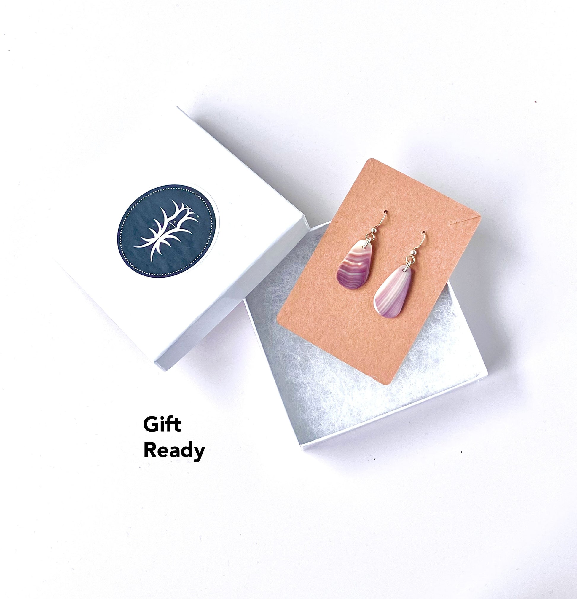 Earrings are shipped in our signature gift box shown against a white background.