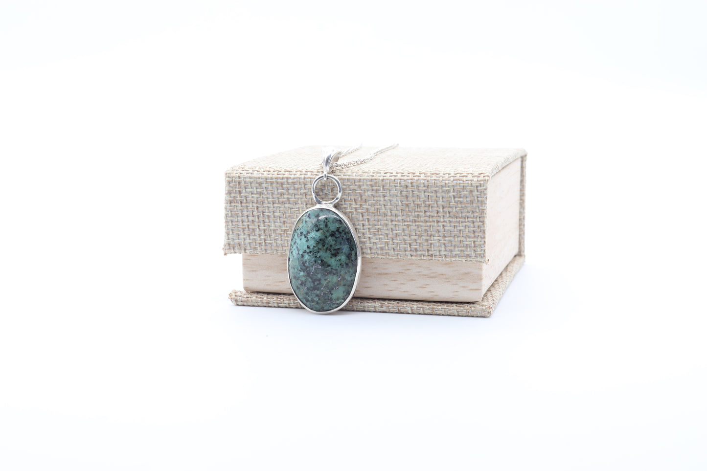 Necklace with a pendant on a white background shown with gift box.