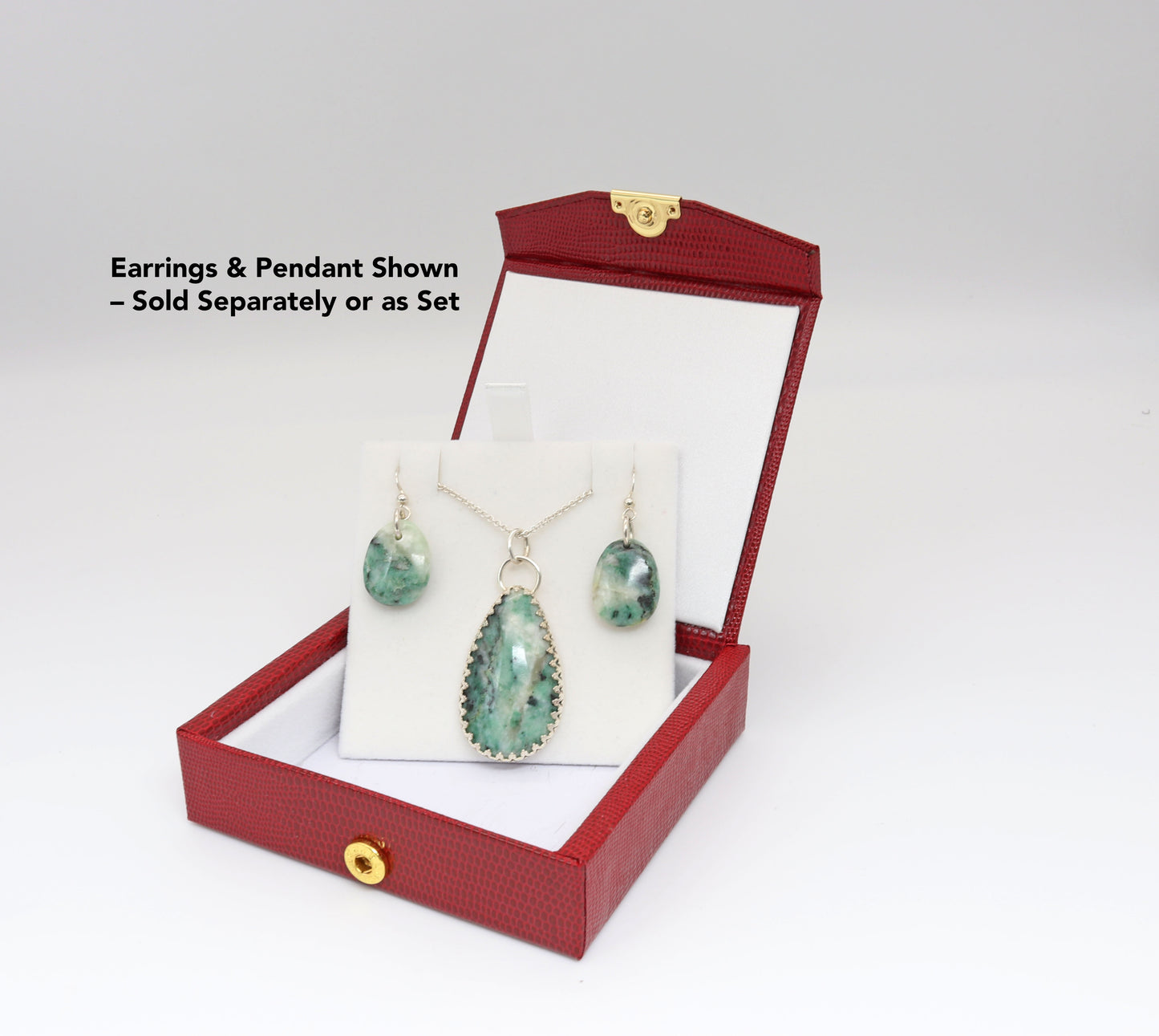 African Turquoise Pendant and African Turquoise teardrop dangle earrings shown in gift boxe, ready to present. Both are hand-cut and polished to reveal the stone’s signature blend of teal, green, and creamy white. Earrings & Pendant Shown – Sold as Set.