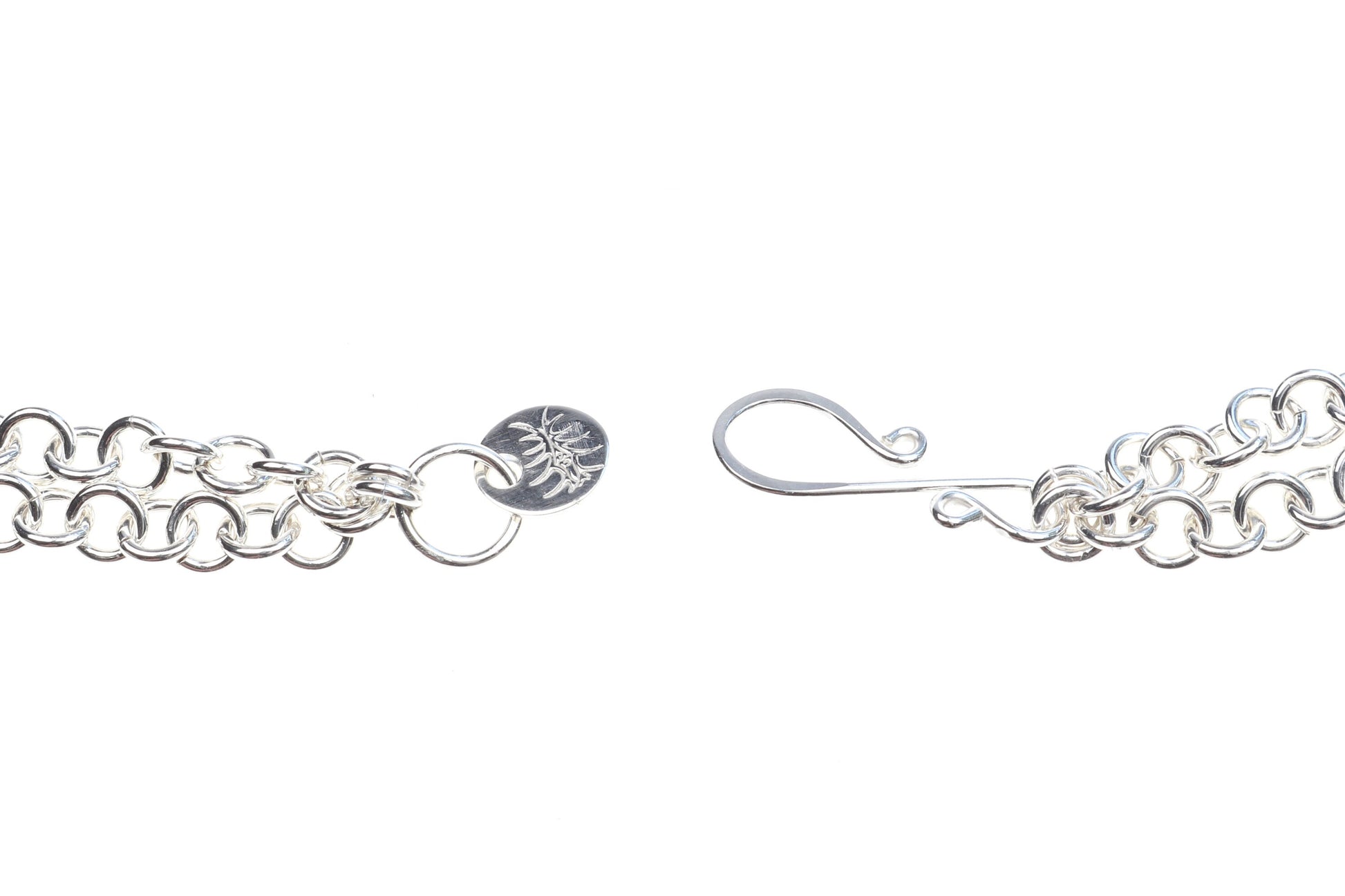 Handcrafted in our studio is a uniquely elegant creation: the Petrified Rainbow Wood Pendant set in sterling Argentium® 935 Silver, accompanied by a custom dual cable chain necklace with S hook Clasp for easy wearing.