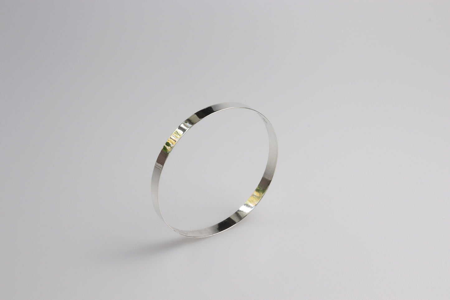 A high Flat Bangle Bracelet in tarnish resistant and hypoallergenic Argentium® 935 silver. Pair with other bracelets for that modern and sophisticated look.
