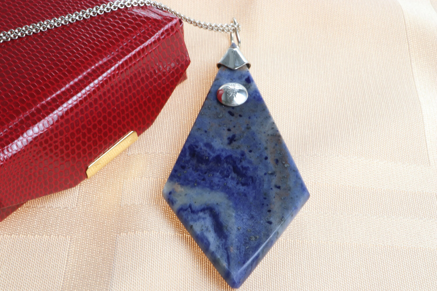 A large 3.23 inch distinctive, rare and remarkable Foidolite igneous rock, expertly cut into a kite shape, polished, and elegantly presented with a custom crafted Argentium® Silver bail setting. Ready to gift in faux red leather gift box.