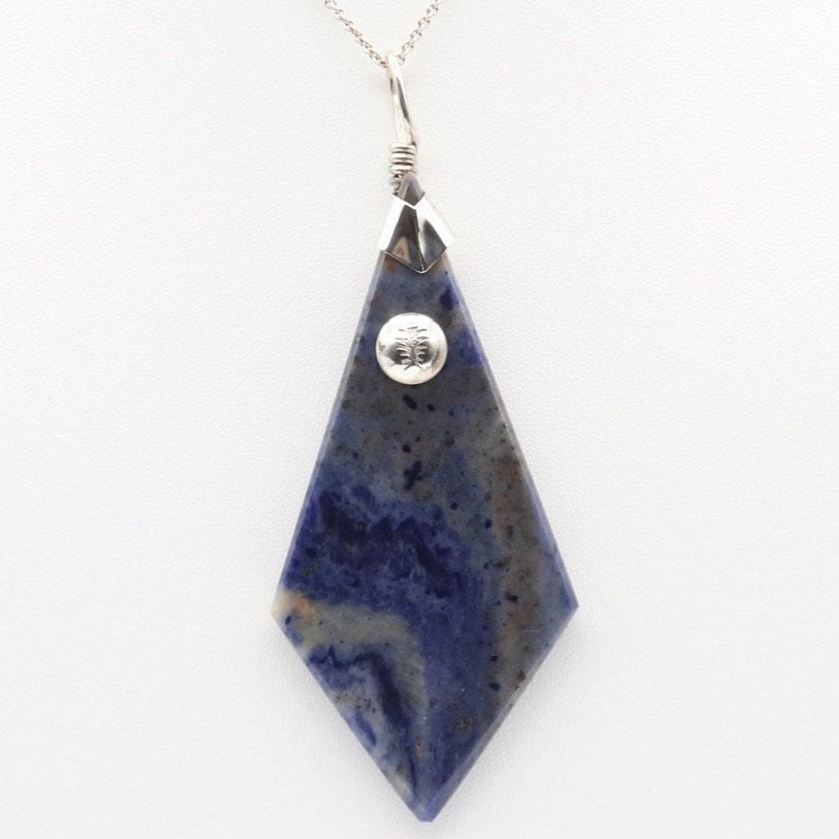 A distinctive, rare and remarkable Foidolite igneous rock, expertly cut into a kite shape, polished, and elegantly presented with a custom crafted Argentium® Silver bail setting.