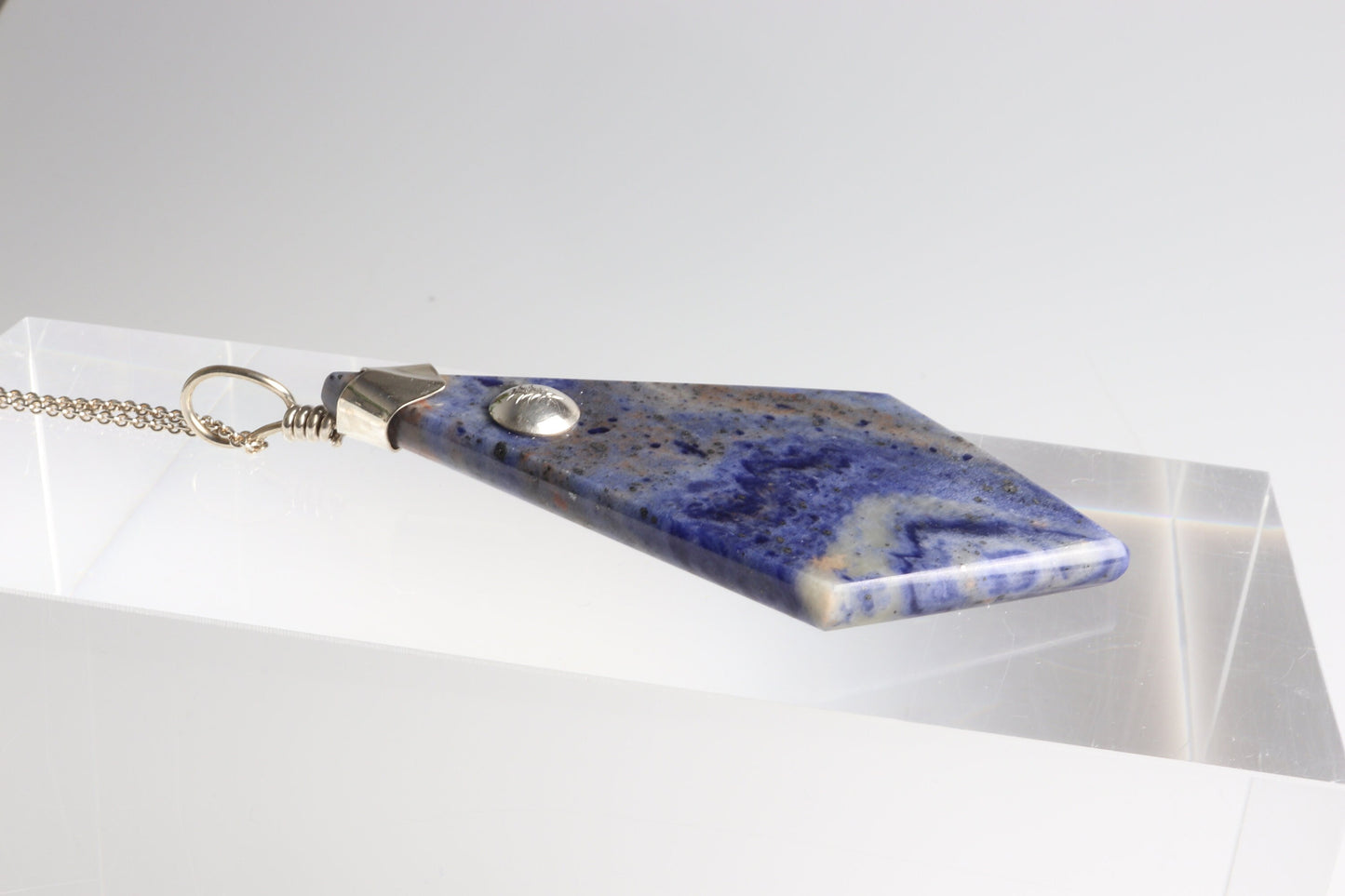 A large distinctive, rare and remarkable Foidolite igneous rock, expertly cut into a kite shape, polished, and elegantly presented with a custom crafted Argentium® Silver bail setting.