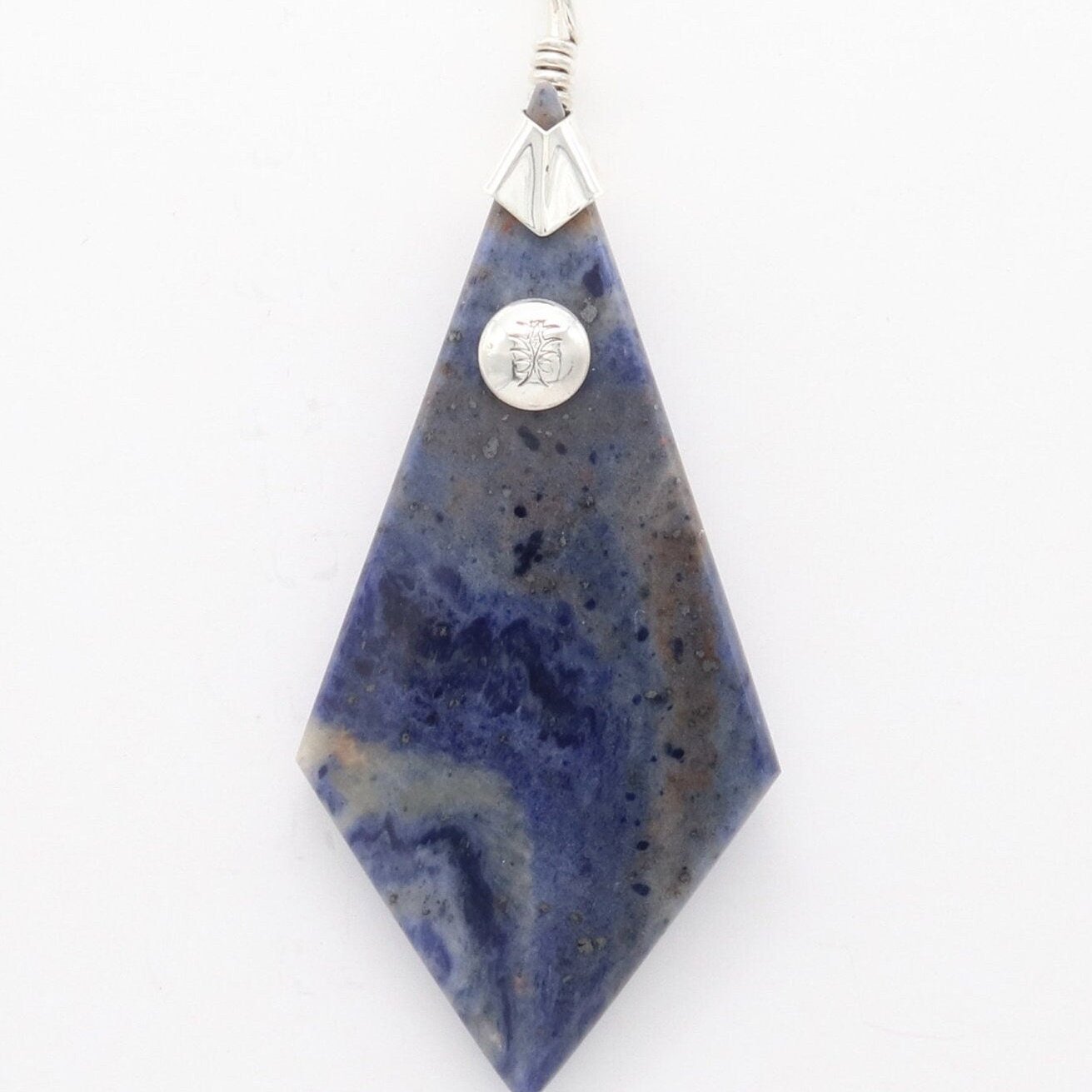 A distinctive, rare and remarkable Foidolite igneous rock, expertly cut into a kite shape, polished, and elegantly presented with a custom crafted Argentium® Silver bail setting.