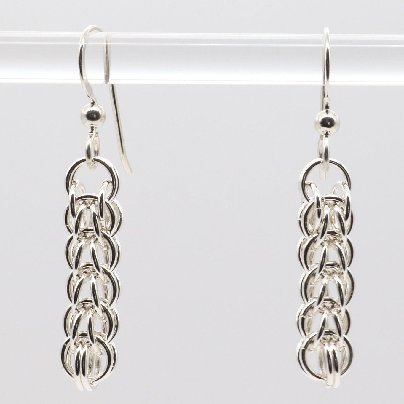 Our handcrafted solid silver dangle earrings, showcase a mesmerizing full Persian weave pattern, featuring interlocking links that create a captivating visual effect in premium sterling 935 Argentium® silver. The 935 Argentium® Silver ear wires, add a touch of elegance, ensure a comfortable and secure fit and are hypoallergenic.
