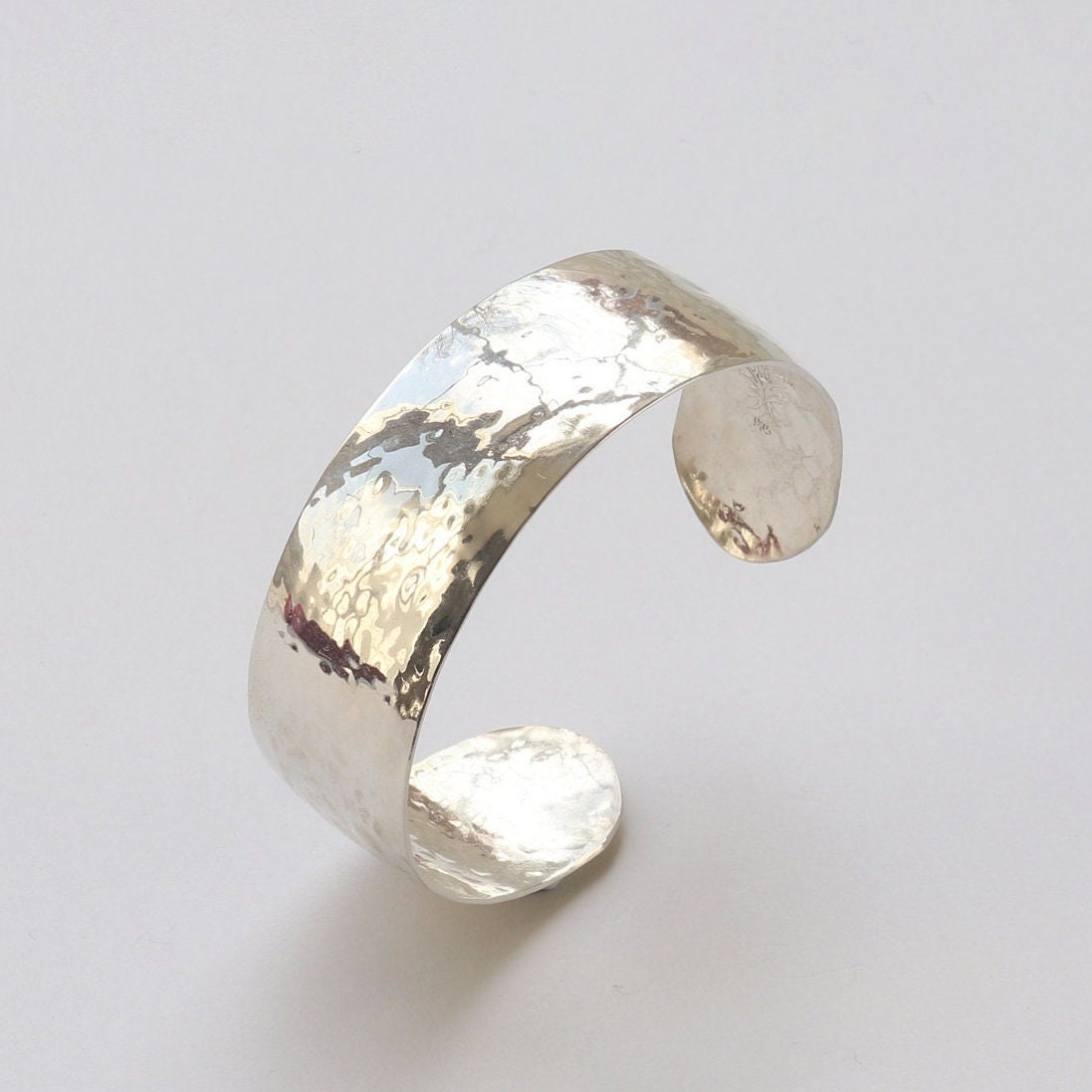 Handcrafted in our Missouri studio is this .75 inch solid sterling 935 Argentium Silver Synclastic Bump Cuff Bracelet with a 2 inch inside diameter.