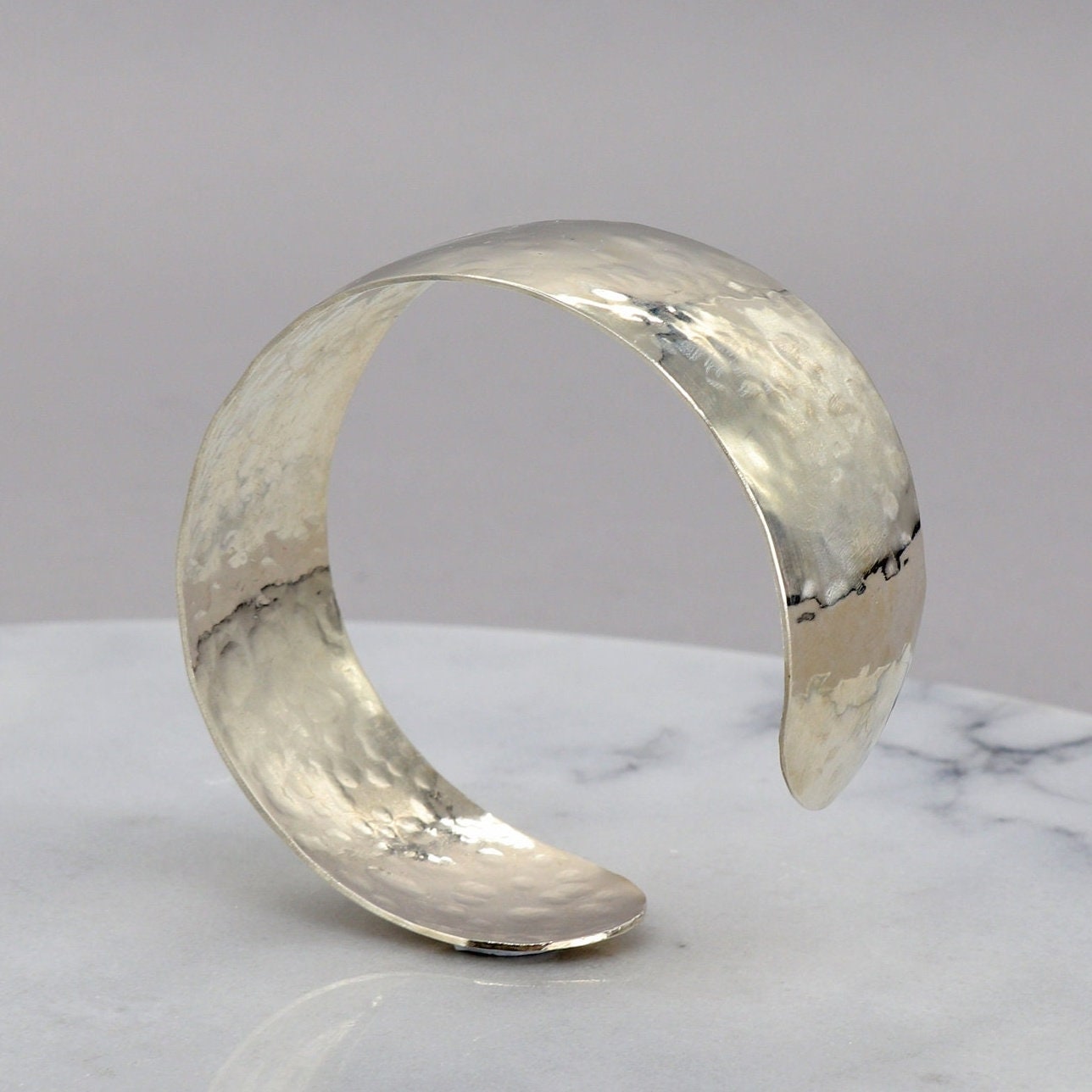 Handcrafted in our Missouri studio is this .75 inch solid sterling 935 Argentium Silver Synclastic Bump Cuff Bracelet with a 2 inch inside diameter.