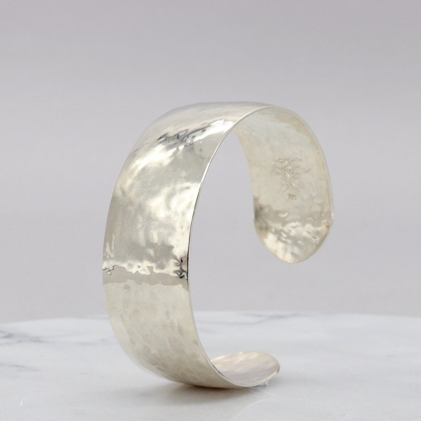 Handcrafted in our Missouri studio is this .75 inch solid sterling 935 Argentium Silver Synclastic Bump Cuff Bracelet with a 2 inch inside diameter.