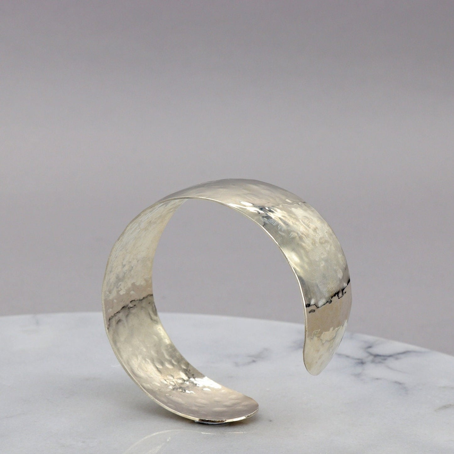 Handcrafted in our Missouri studio is this .75 inch solid sterling 935 Argentium Silver Synclastic Bump Cuff Bracelet with a 2 inch inside diameter.