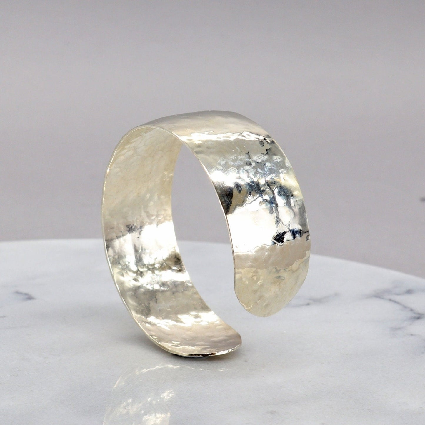 Handcrafted in our Missouri studio is this .75 inch solid sterling 935 Argentium Silver Synclastic Bump Cuff Bracelet with a 2 inch inside diameter.