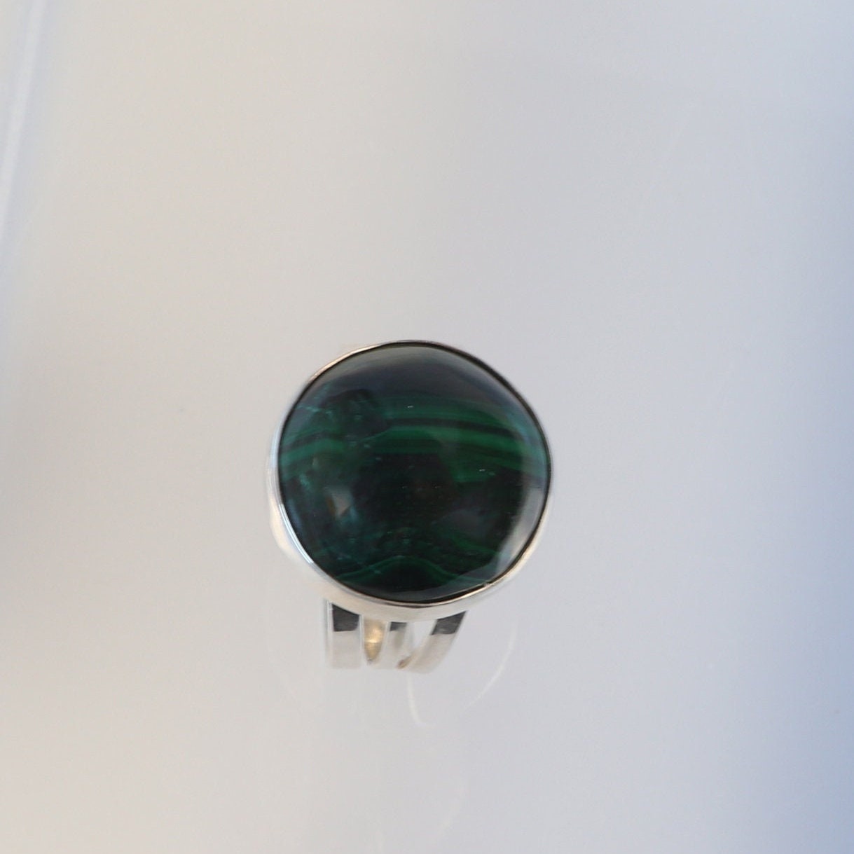 A handcrafted one-of-a-kind cabochon Malachite gemstone men's ring, handcut and polished in our Missouri studio. The ring is crafted from fine silver, and sterling Argentium® 935 Silver renowned for its resistance to tarnishing and its durable quality.