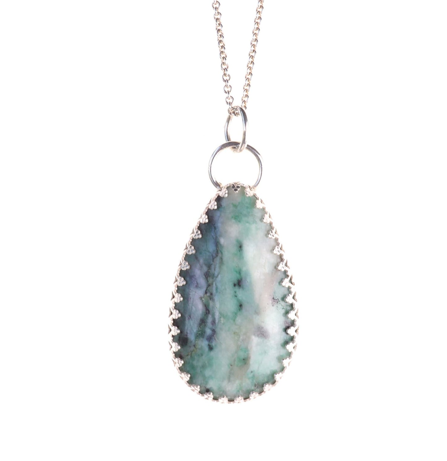 A natural 2.12 inch African Turquoise gemstone, handcut and polished in our Missouri studio to reveal its earthy patterns and hues of teal, green and creamy white. Reminiscent of real turquoise, this African Turquoise gemstone boasts its own unique patterns and variations, making every piece truly one-of-a-kind. Set in a custom 935 Argentium setting paired with a complementary 18 inch chain.
