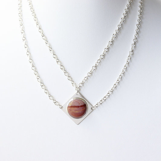 Handcrafted in our studio is a uniquely elegant creation: the Petrified Rainbow Wood Pendant set in sterling Argentium® 935 Silver, accompanied by a custom dual cable chain necklace with S hook Clasp for easy wearing.
