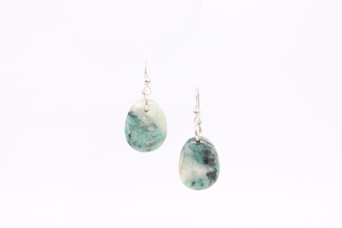 Natural African Turquoise tear drop earrings, handcut and polished in our Missouri studio to reveal earthy patterns and hues of teal, green and creamy white. Reminiscent of real turquoise, African Turquoise boasts its own unique patterns and variations, making every piece truly one-of-a-kind. The sterling 935 Argentium® Silver ear wires, add a touch of elegance, ensure a comfortable and secure fit and are hypoallergenic.
