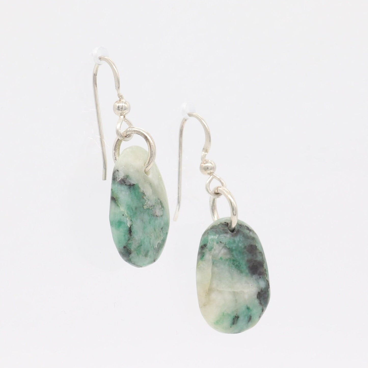Natural African Turquoise tear drop earrings, handcut and polished in our Missouri studio to reveal earthy patterns and hues of teal, green and creamy white. Reminiscent of real turquoise, African Turquoise boasts its own unique patterns and variations, making every piece truly one-of-a-kind. The sterling 935 Argentium® Silver ear wires, add a touch of elegance, ensure a comfortable and secure fit and are hypoallergenic.