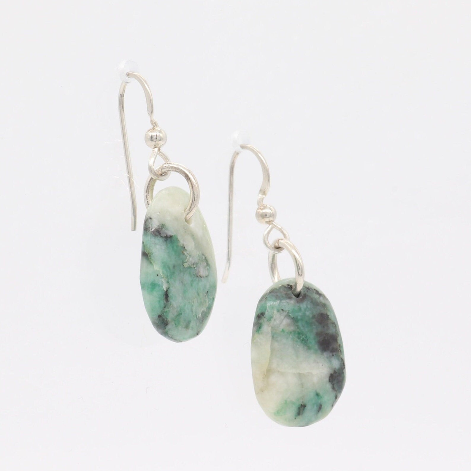 Natural African Turquoise tear drop earrings, handcut and polished in our Missouri studio to reveal earthy patterns and hues of teal, green and creamy white.  Reminiscent of real turquoise, African Turquoise boasts its own unique patterns and variations, making every piece truly one-of-a-kind.   The sterling 935 Argentium® Silver ear wires, add a touch of elegance, ensure a comfortable and secure fit and are hypoallergenic.