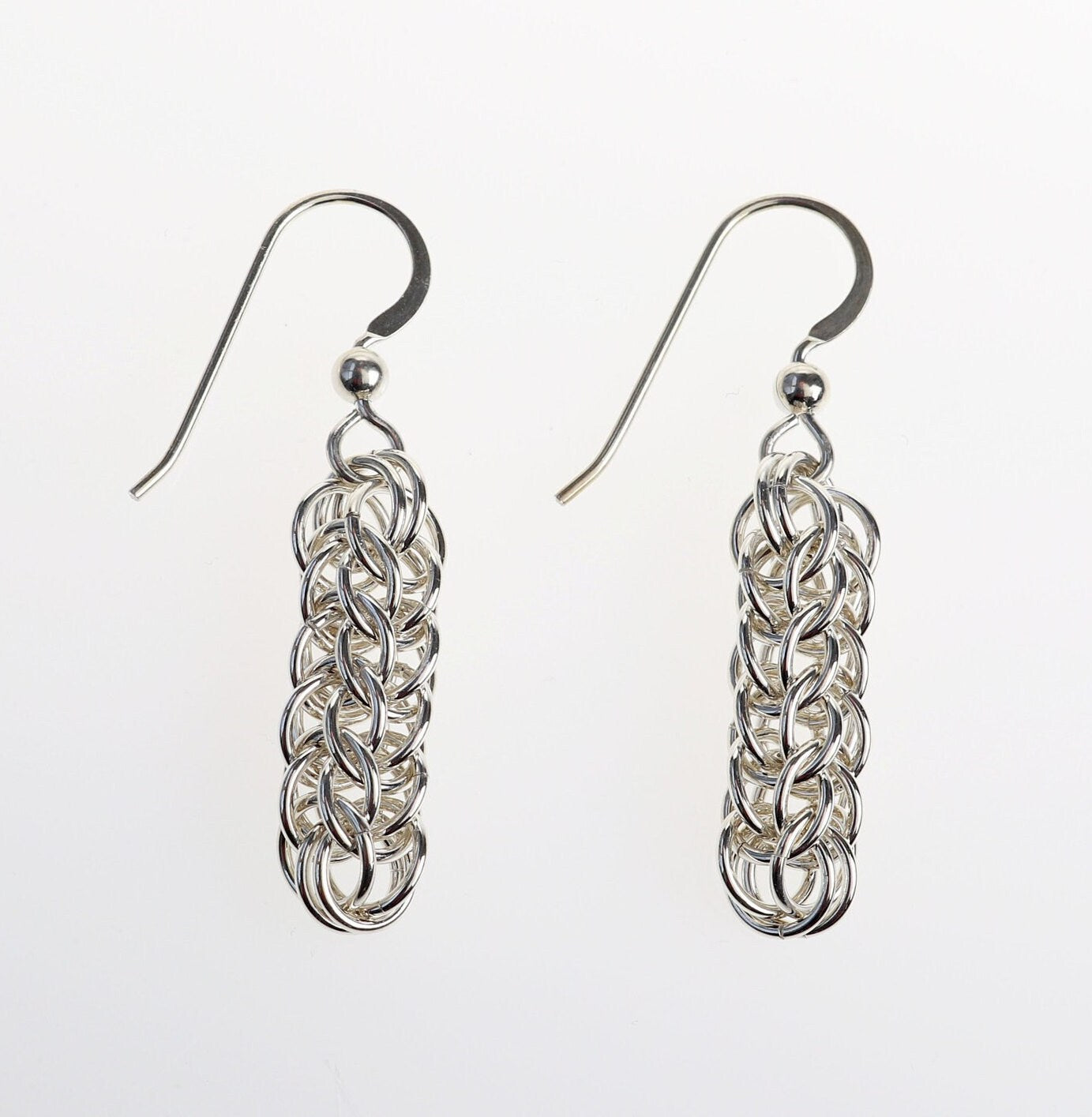 Our handcrafted solid silver dangle earrings, showcase a mesmerizing full Persian weave pattern, featuring interlocking links that create a captivating visual effect in premium sterling 935 Argentium® silver. The 935 Argentium® Silver ear wires, add a touch of elegance, ensure a comfortable and secure fit and are hypoallergenic.