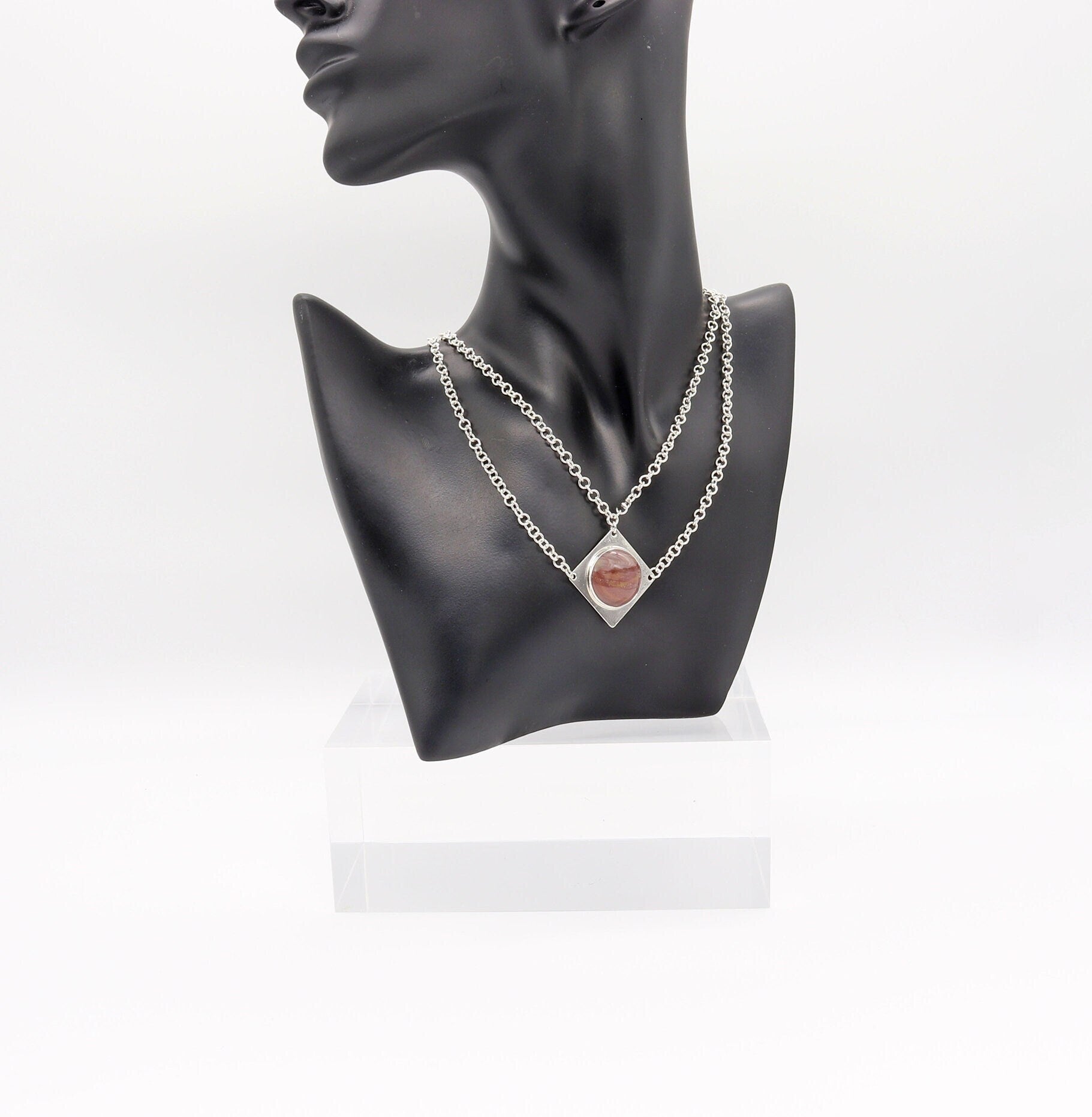 Handcrafted in our studio is a uniquely elegant creation: the Petrified Rainbow Wood Pendant set in sterling Argentium® 935 Silver, accompanied by a custom dual cable chain necklace with S hook Clasp for easy wearing.