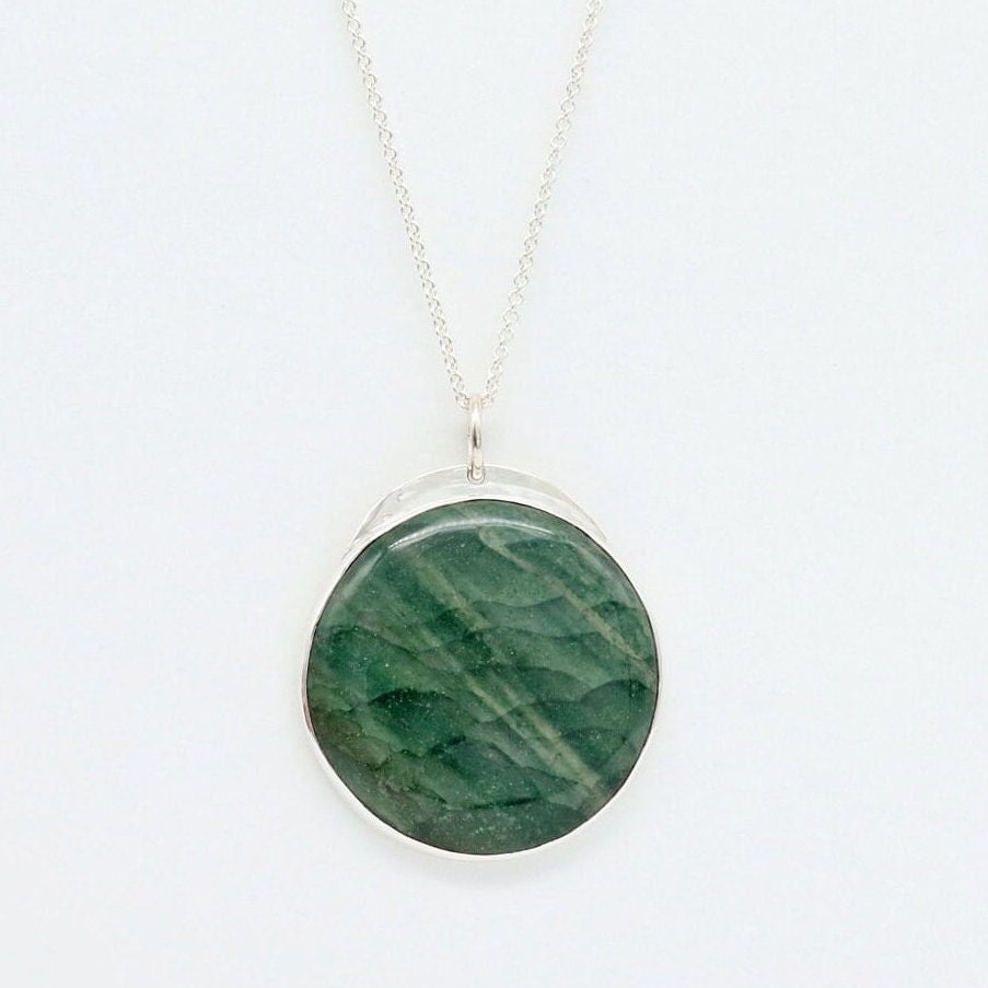 Introducing our handcrafted 1.88 inch Arizona Green Lizard Gemstone Pendant Necklace, in Sterling 935 Argentium Silver. The gemstone was handcut and polished (in our Missouri Studio) into a smooth cabochon to showcase the stunning green hues and natural patterns of the stone. To complete the look a complementary sterling 935 Argentium chain is included.