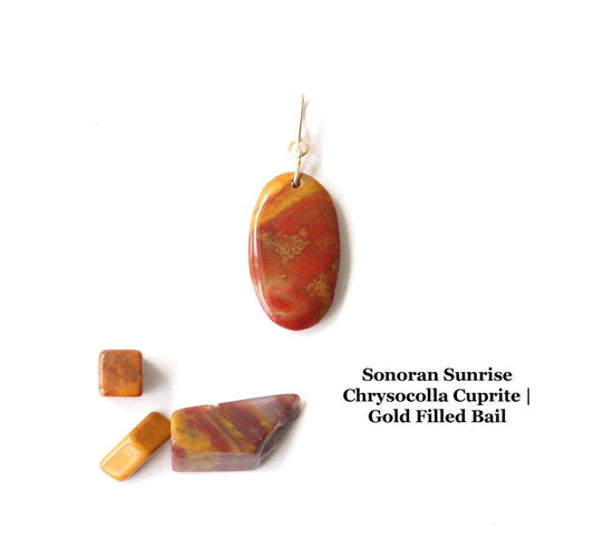 A hand-cut and polished on both sides Sonoran Sunrise natural stone pendant.  This pendant features a vivid blend of brilliant red cuprite and sun-baked golden tones with hints of mustard yellow, hand-cut and polished in our Missouri studio. Finished with a custom infinity bow bail in 14/20 gold-filled wire.
