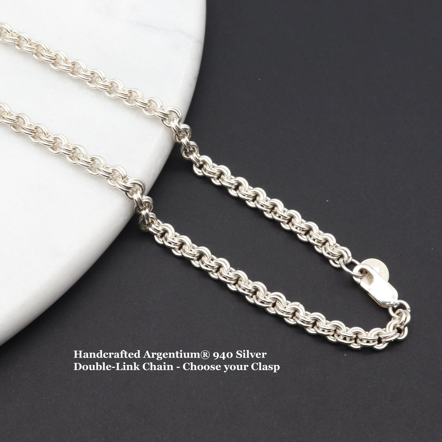 Argentium® 940 Silver Double-Link Chain - Choose your Clasp and Length.  Shown draped across white marble against black background.