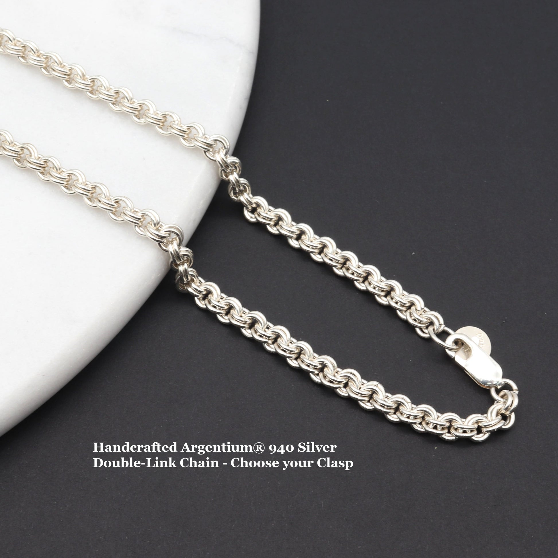 Argentium® 940 Silver Double-Link Chain - Choose your Clasp and Length.  Shown draped across white marble against black background.
